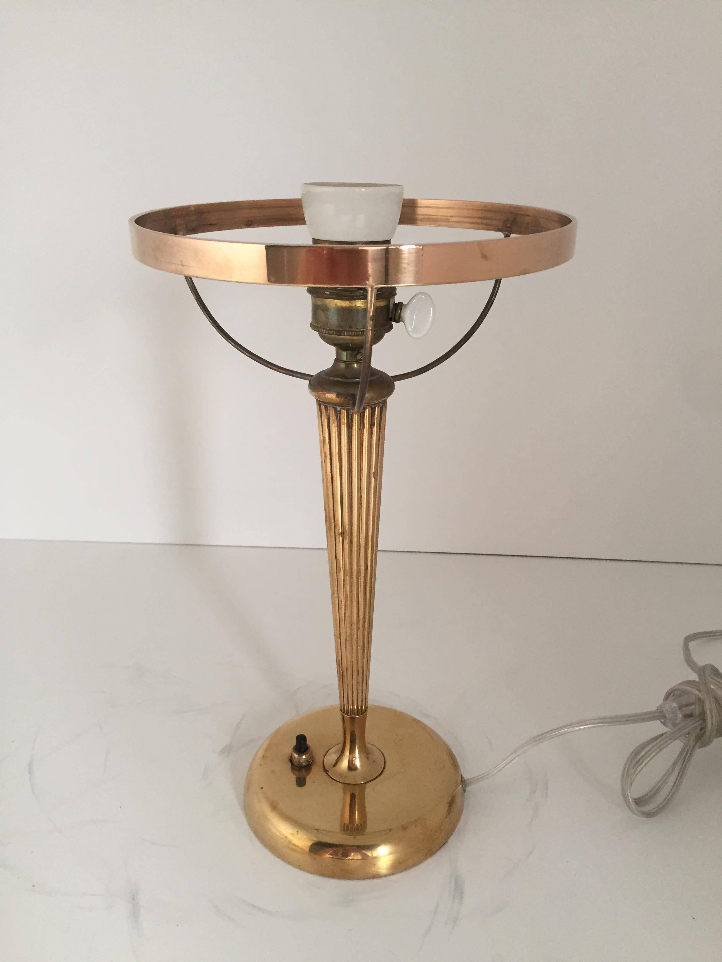 A beautiful 1925-1930 brass table lamp with a nice light bluegreen glass shade, most likely made by Böhlmarks. The height is 41cm and the diameter of the shade is 21cm. There is a small chip on the shade that has been reglued back, this is nothing