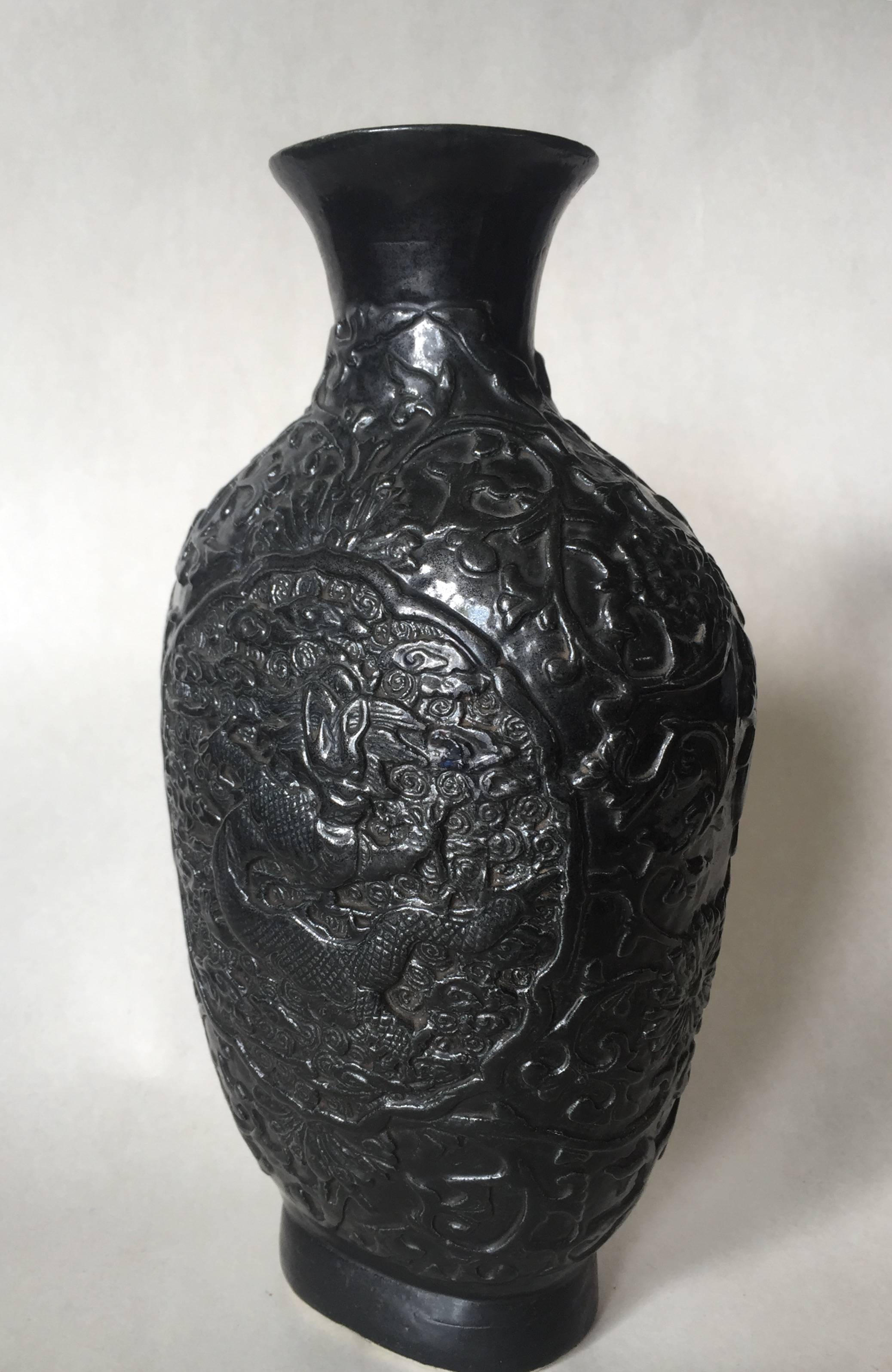 Late 19th century Chinese Qianlong mark Bisque relief dragon vase.
The relief decor imitation bronze is full of scrolls of leaf, chrysanthemum flowers among the Dragon cartouches in the middle of each side of the vase.
This vase has been used as a