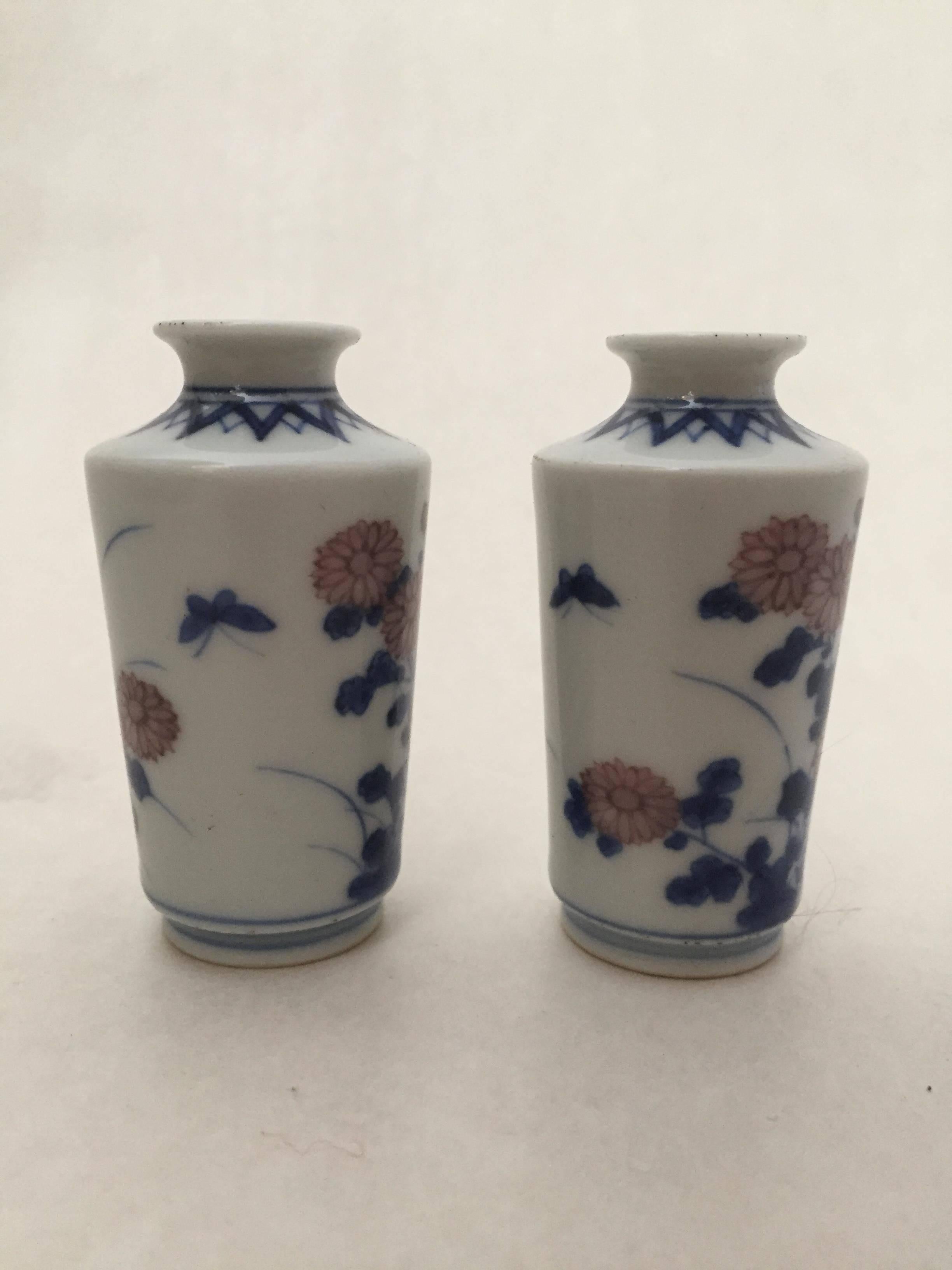 Pair of 18th century Chinese underglaze blue and red miniature cabinet vases. This pair was most likely made during the Qianlong reign during the 18th century. The vases depicts chrysanthemum flowers and butterflies which both are symbols for