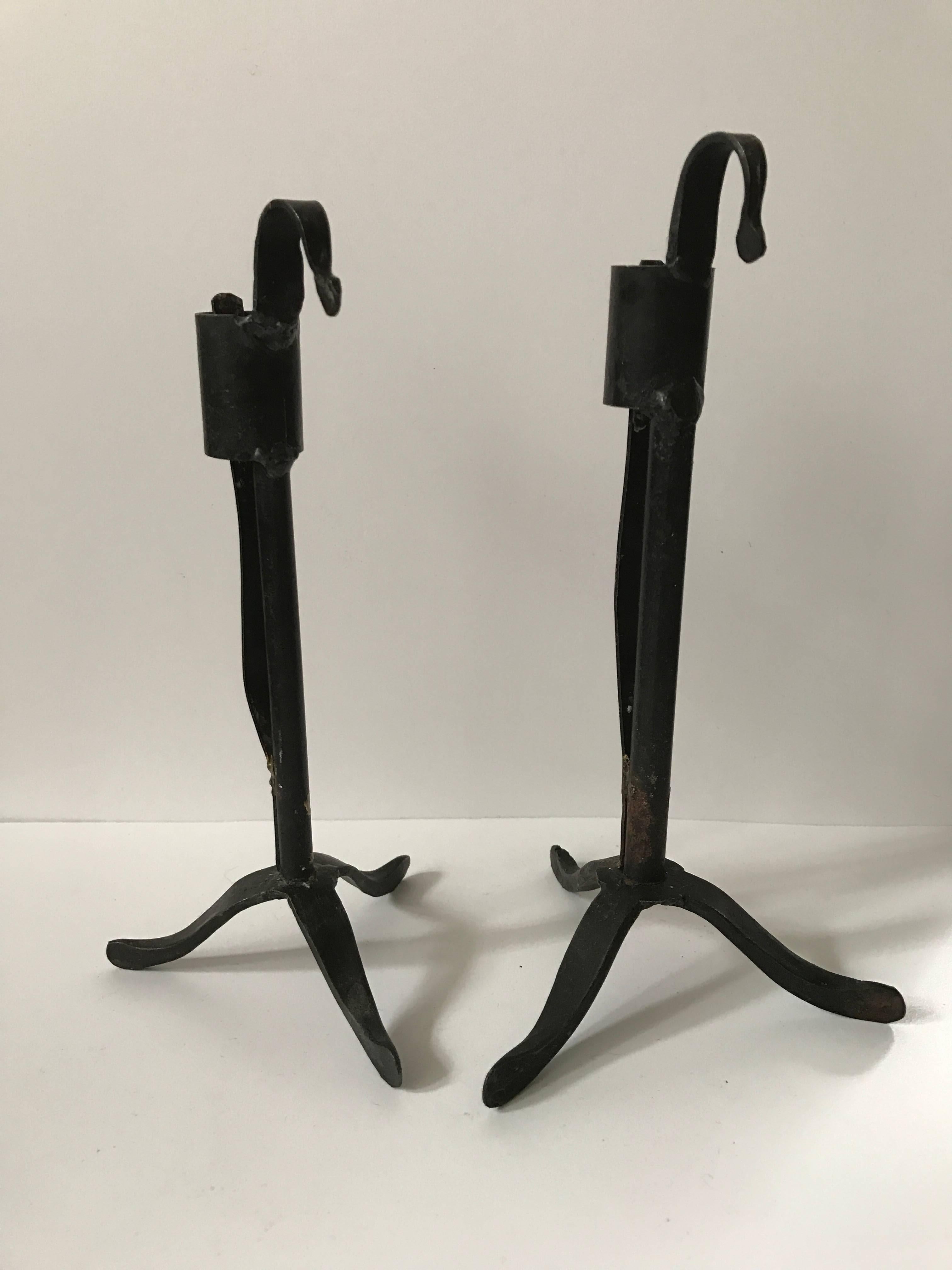 A nice pair of Swedish wrought iron candle sticks, made in the late 19th century. They have different heights and the base differs in wideness, otherwise they look the same. The height of the two are 19 and 20 cm.
