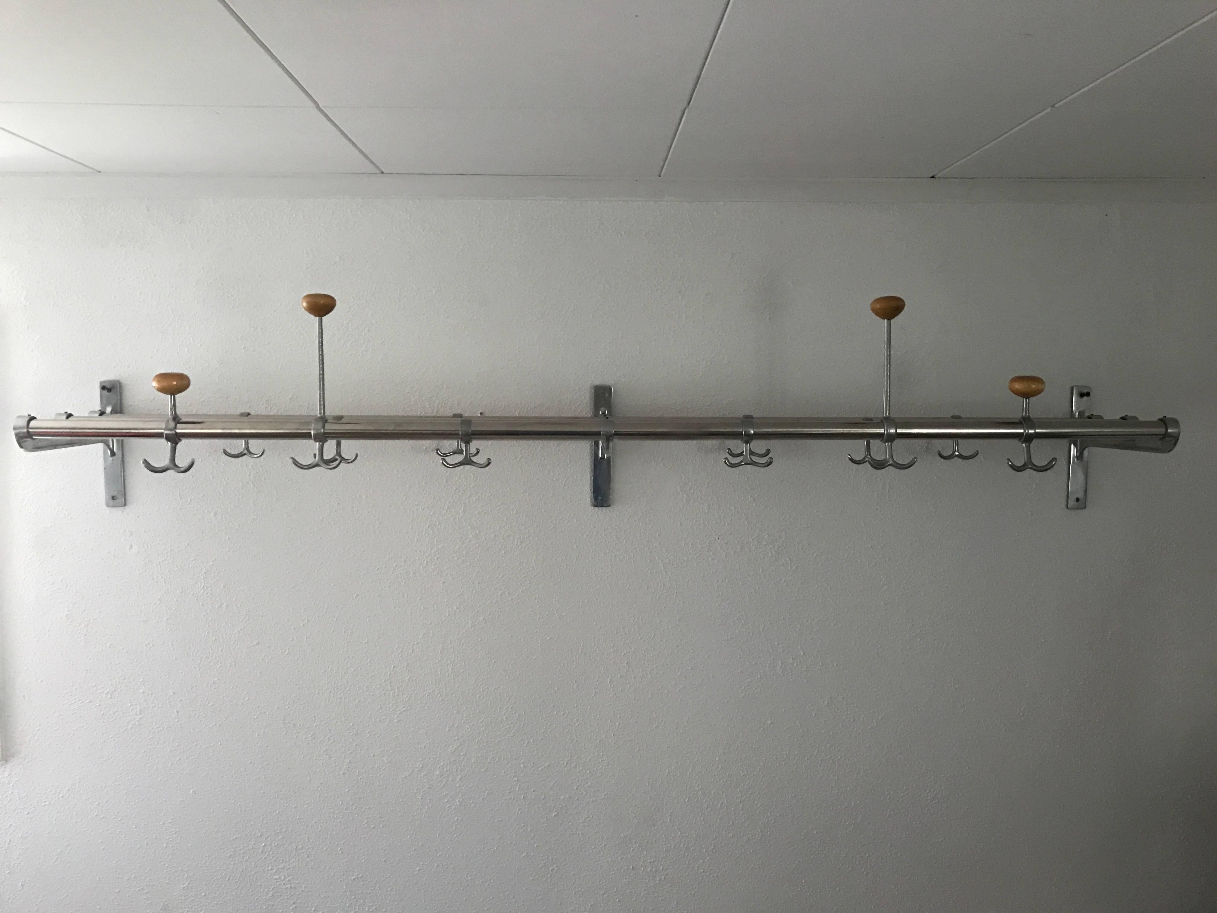 A very nice Swedish coat rack made of stainless steel and aluminium hangers and ends. This was most likely made 1945-1950 and it is in a very nice condition. Measure: It is 150cm in length and 25cm deep, it has four hat hangers and 12 double coat