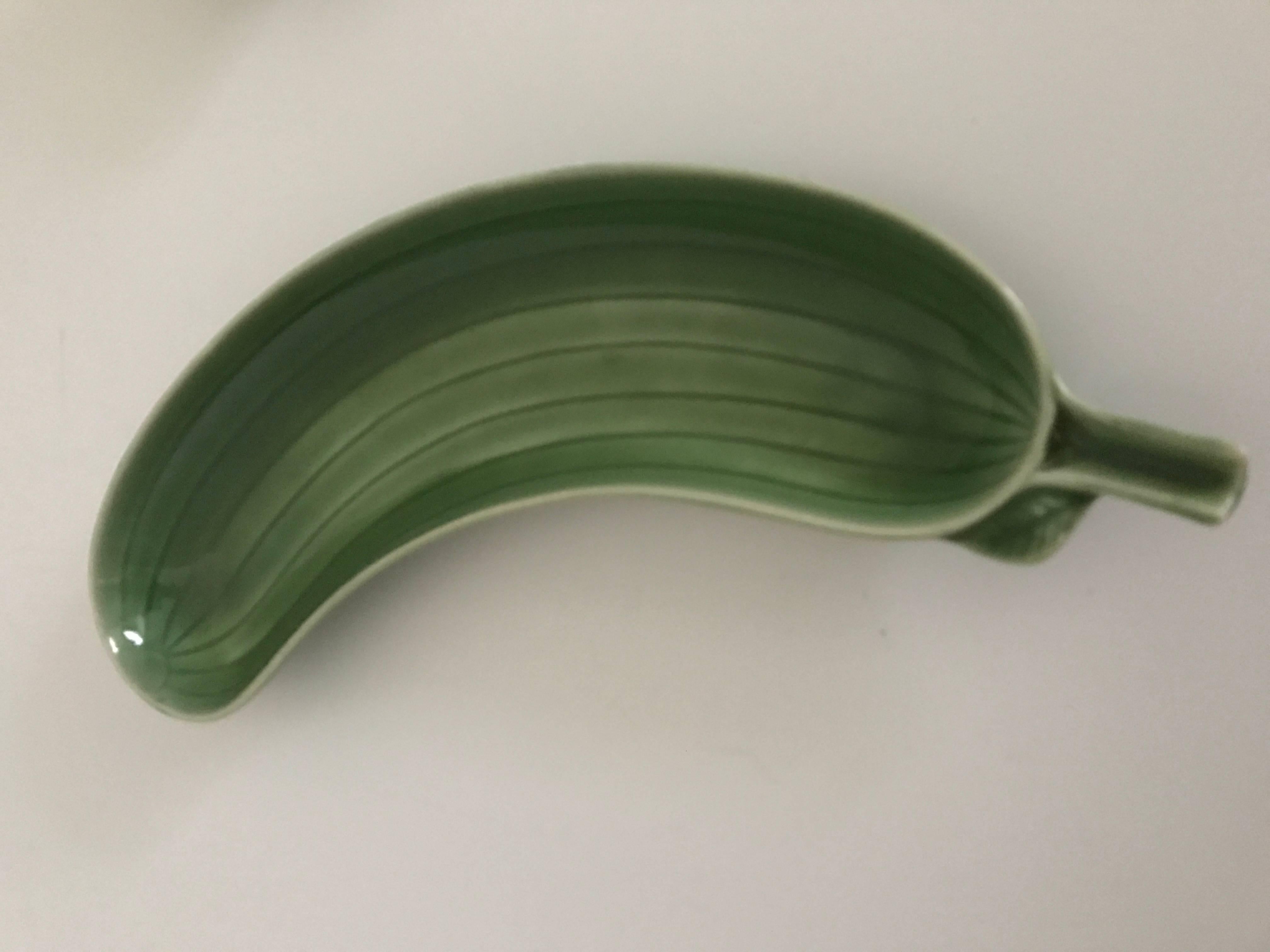 Late 20th century Gustavsberg Stig Lindberg Swedish ceramic cucumber dish.
A beautiful and funny set of four serving dishes shaped like a cucumber. These dishes are made and designed by one of Sweden´s most famous ceramic artists, Stig Lindberg at