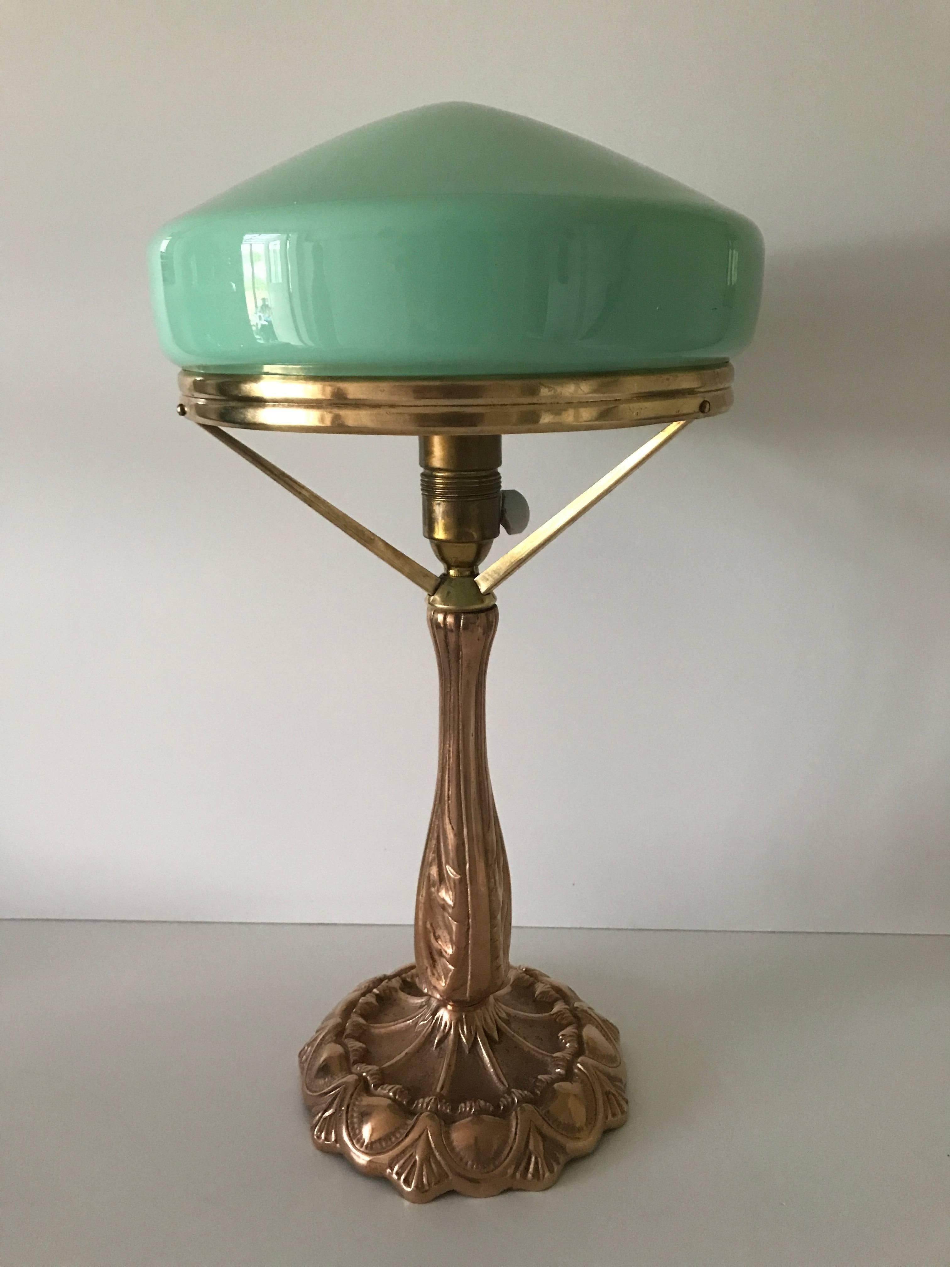 1925 Swedish Jugendstil, Art Nouveau brass and glass table lamp.
A nice large table lamp where the manufacturer is unknown, the shade is most likely made at Pukeberg glass factory, the height is 48cm and the shade has a diameter of 26cm. The lamp