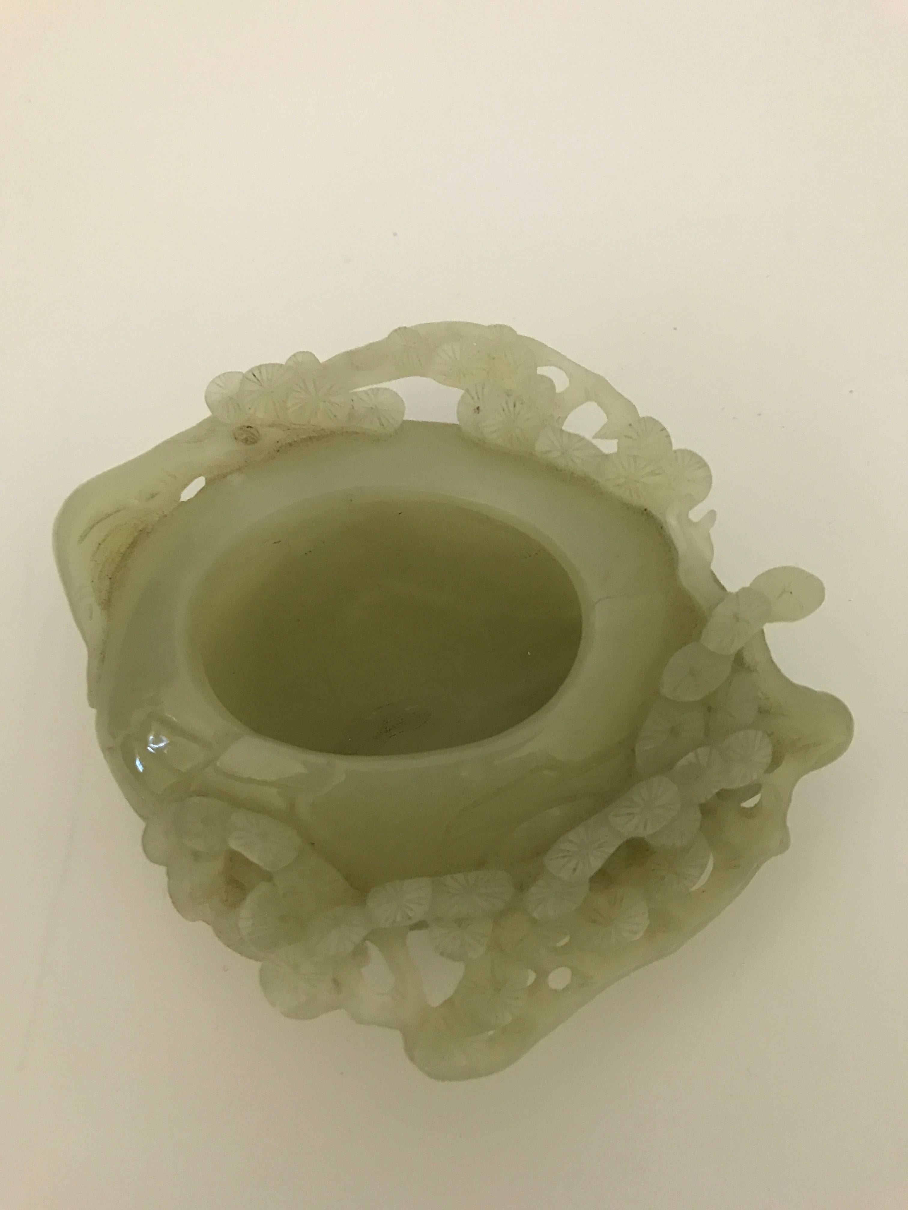 20th century carved Chinese Green Jade brush washer. There are twigs of pine that surrounds the washer and is carved nicely, There is, what we believe and what looks like a tiny chip, that is hardly visible on the pine carving, but nothing you will