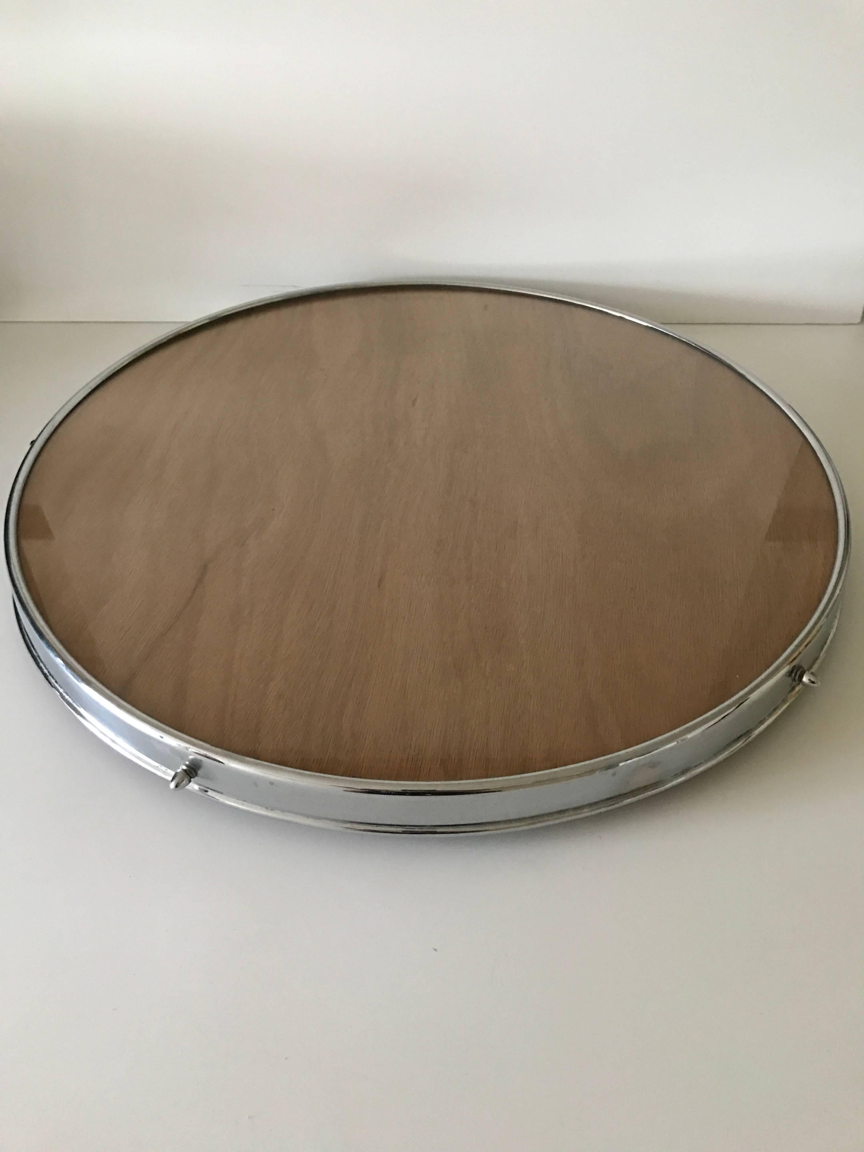 1950 large Swedish chrome glass and teak spinning serving table.
A very nice serving table to have in the centre of the table when serving many different dishes. It is most likely made in the mid-1950s. The large diameter is 62cm and the height is