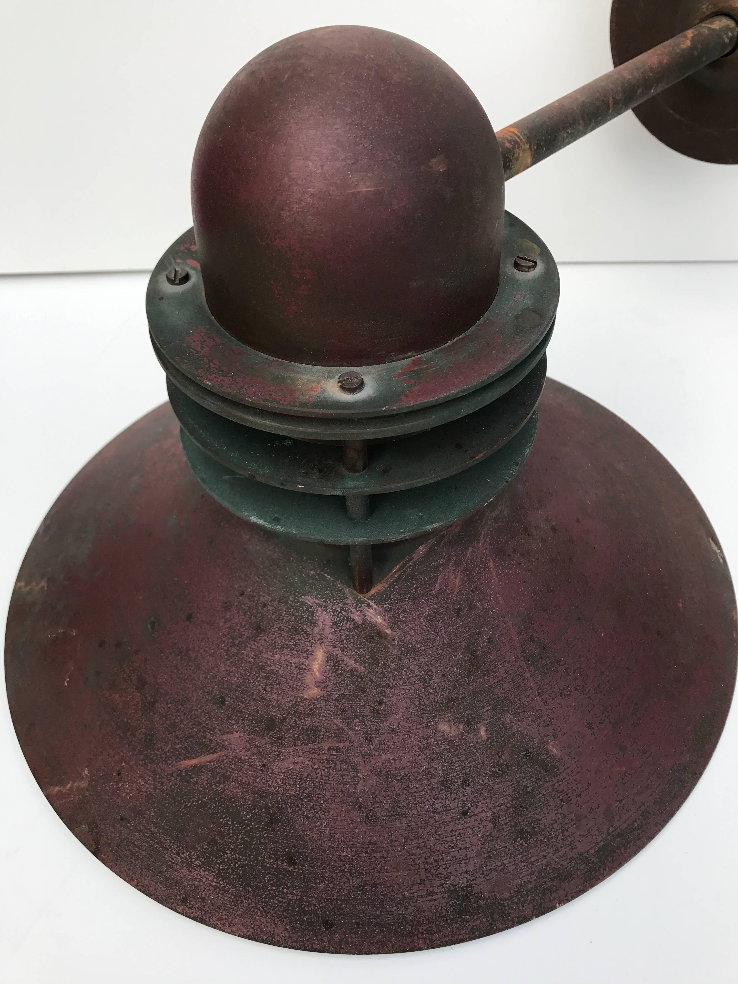 Late 20th century, pair of Louis Poulsen copper outdoor nyhavn wall lamps.
Beautifully aged and patinated copper with a red tone and green copper oxide tone. This pair is most likely made in the late part of the 20th century they are in a fantastic