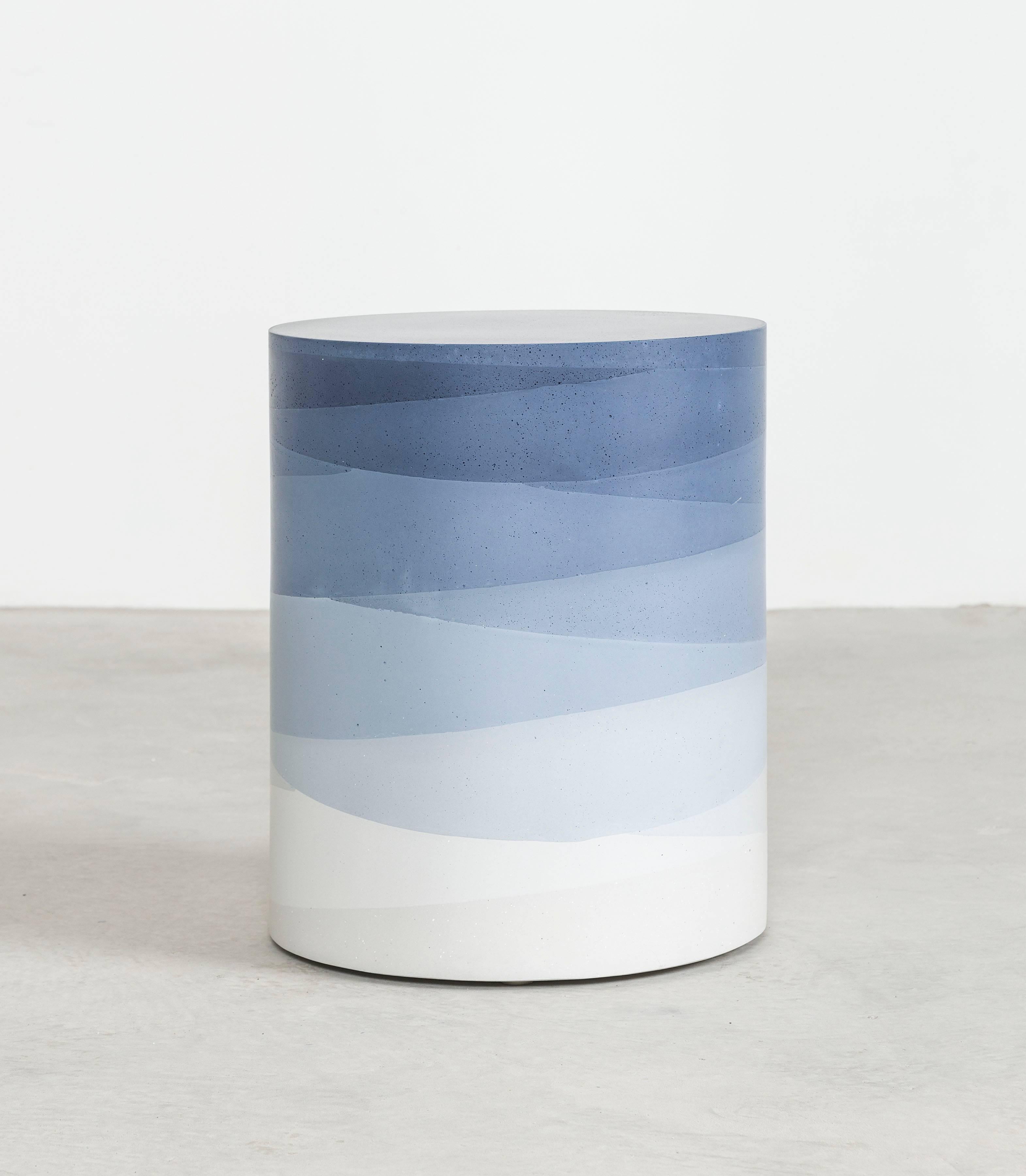 An exploration in the softness and subtly of the materials, the made-to-order drum has a hollow cavity and is cast entirely from hand-dyed cement. Poured in individual hand-dyed layers, starting from the top color indigo and fading to white, the
