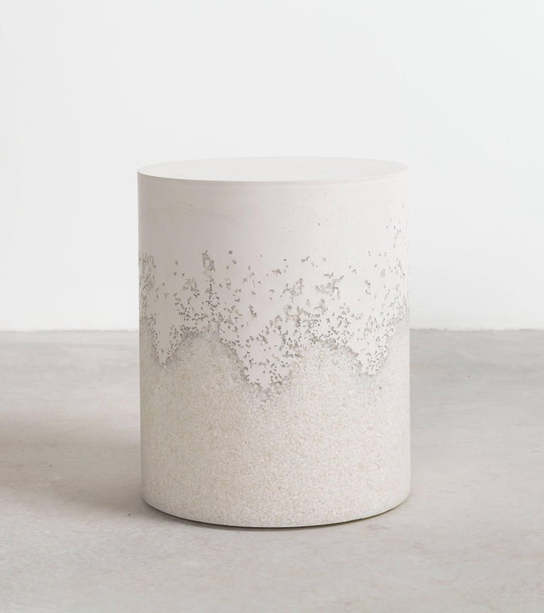 A layering of cement and crushed aggregates, the made-to-order drum consists of a hand-dyed white cement top and a packed crystal quartz bottom. Poured by hand over the jagged minerals, the white cement merges the materials to create a unique