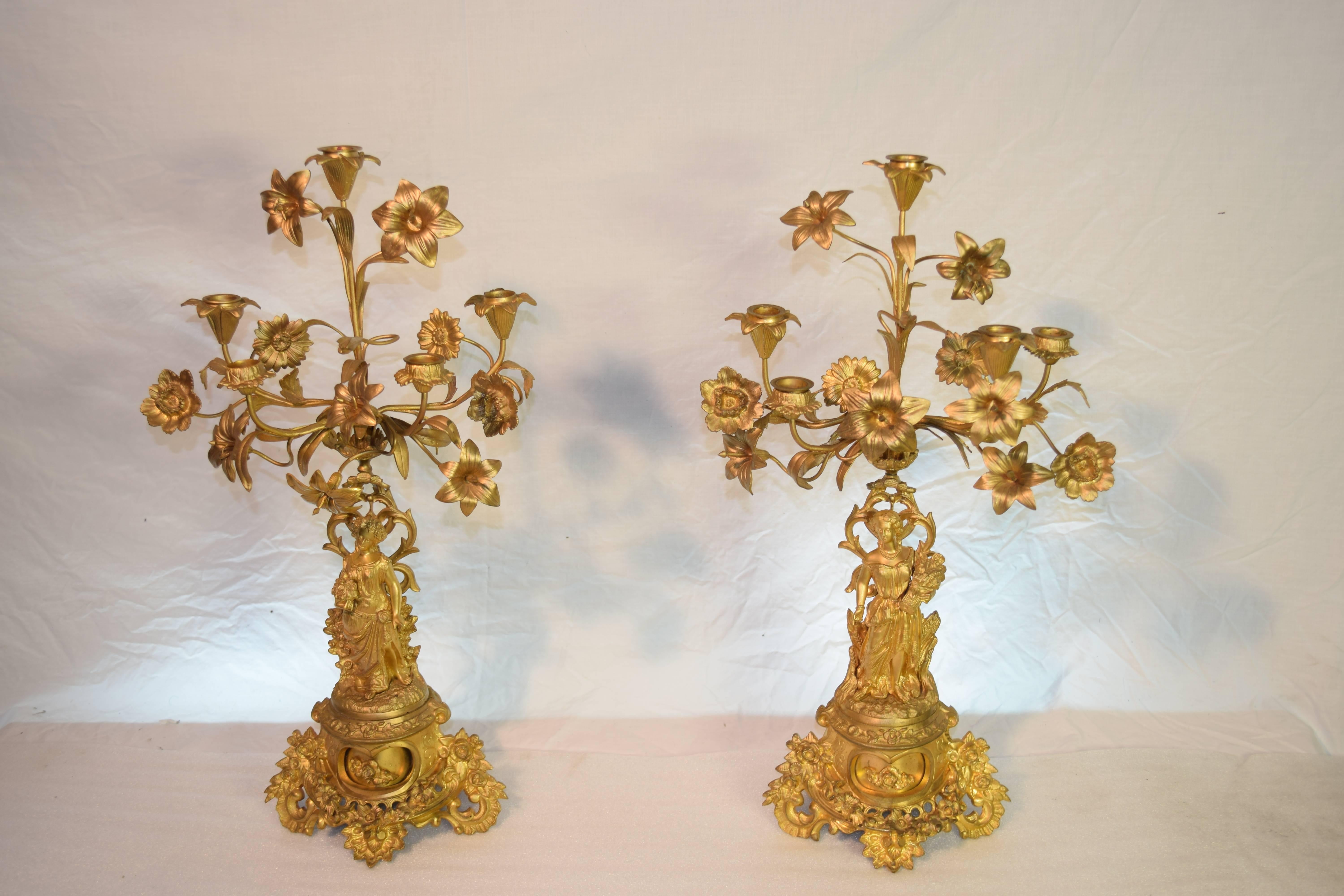 Beautifully decorated French clock set created in the 19th century Romantique st ormolu. Dated 1843.

This is a beautiful antique French clock with two candelabras. It is very typical for the 19th century, or to be more specific, for the