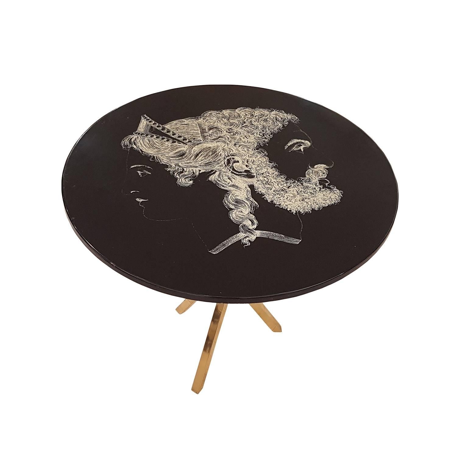 Vintage side table with lacquered wood and decorated with serigraphy, polished brass holder, and manufacturer's label under the tabletop.
Its designer, Piero Fornasetti (Milan 1913 - 1988) is considered among the most original and creative talents