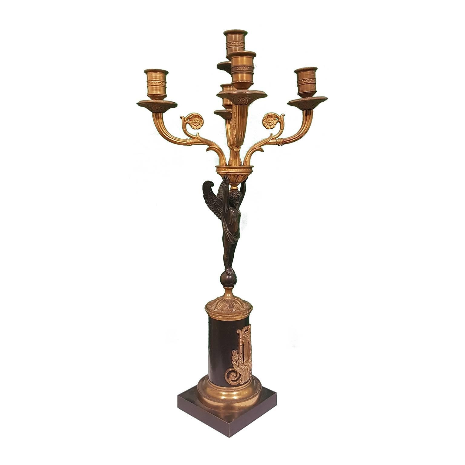Pair of 19th century bronze candleholders with beautiful angel details, featuring five lights, in gilt bronze. They present two angels from which issue five large and beautifully modelled rose branches terminating with candle holders. The angels