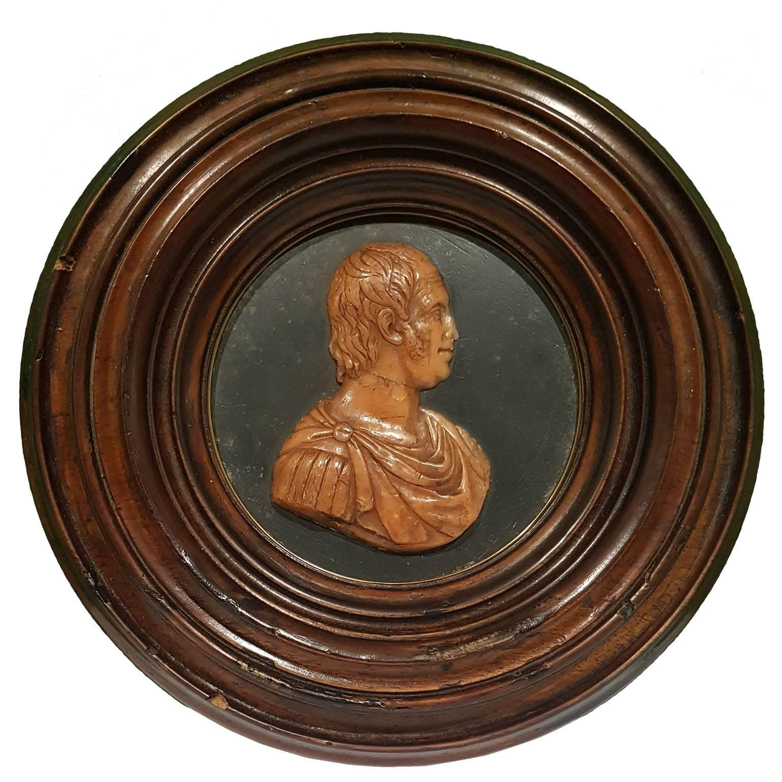 Low relief with Ferdinando IV Borbone' profile as a Roman Emperor, made by patterned wax and coated by a circular walnut wood frame.

This product is located and shipped from Italy.