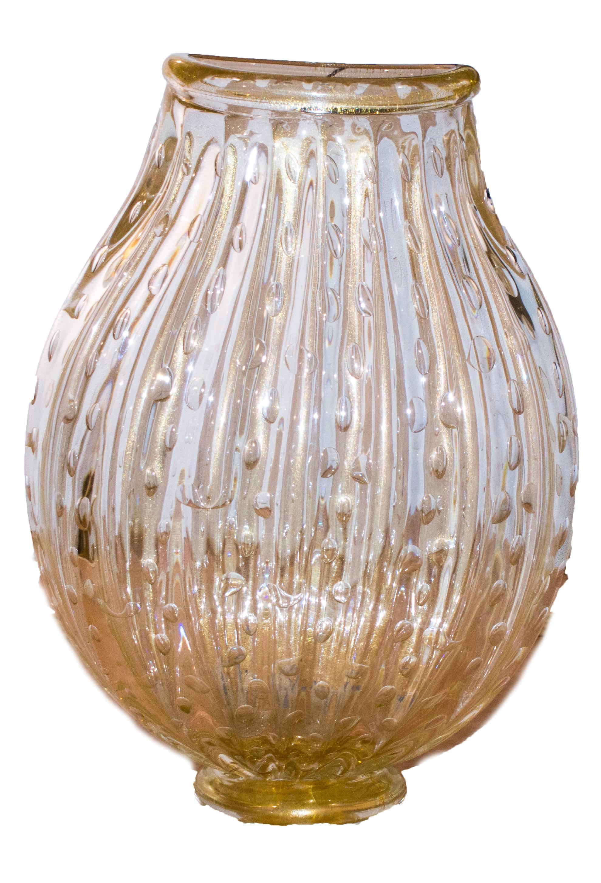 Signed on the base: A.Seguso, Murano

Sophisticated handblown controlled bubble and gold inclusions vase. The result of the masterwork of Archimede Seguso, Murano.
 