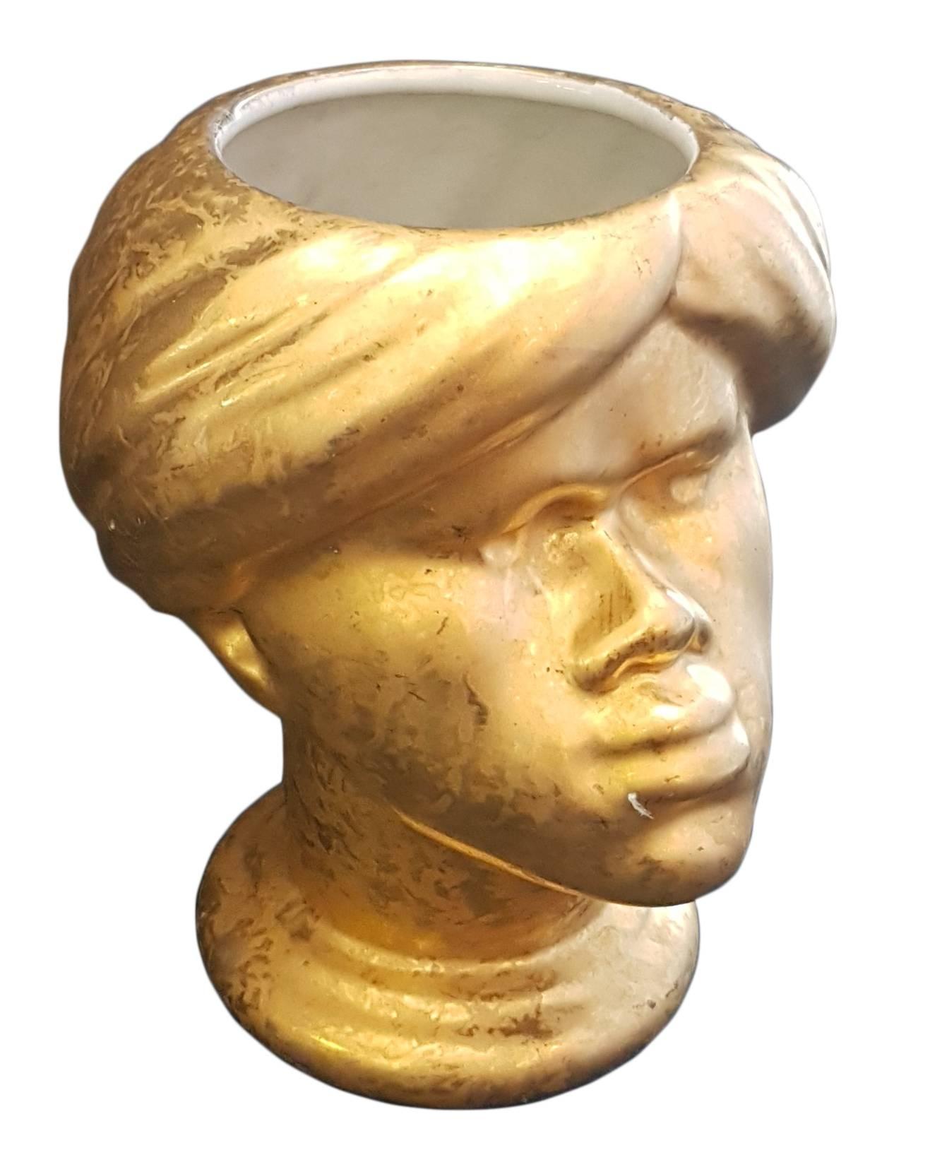 Magnificent enameled gold ceramic vase by Piero Fornasetti (Milan 1913-1988), considered among the most original and creative talents of the 21st century. 
A rare piece depicting the head of a Moor.
Little scratch below the lips.

The item is