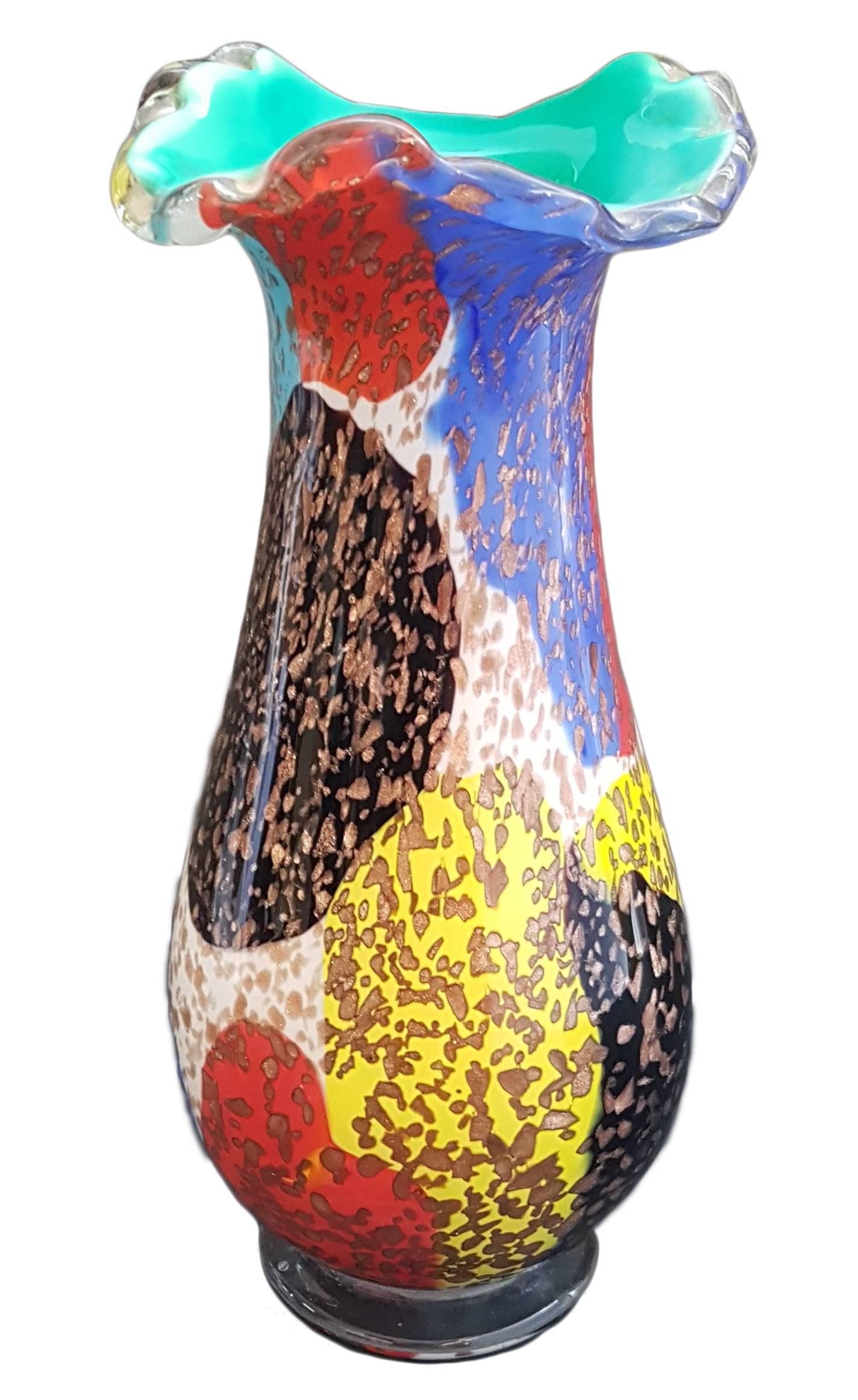 A colourful blown glass vase with aventurine stone by A.Ve.M (Arte Vetraria Muranese), Italy. 
Aventurine is a variety of quartz characterized by bright inclusions of mica or other minerals that give a shimmering or glistening effect to the stone