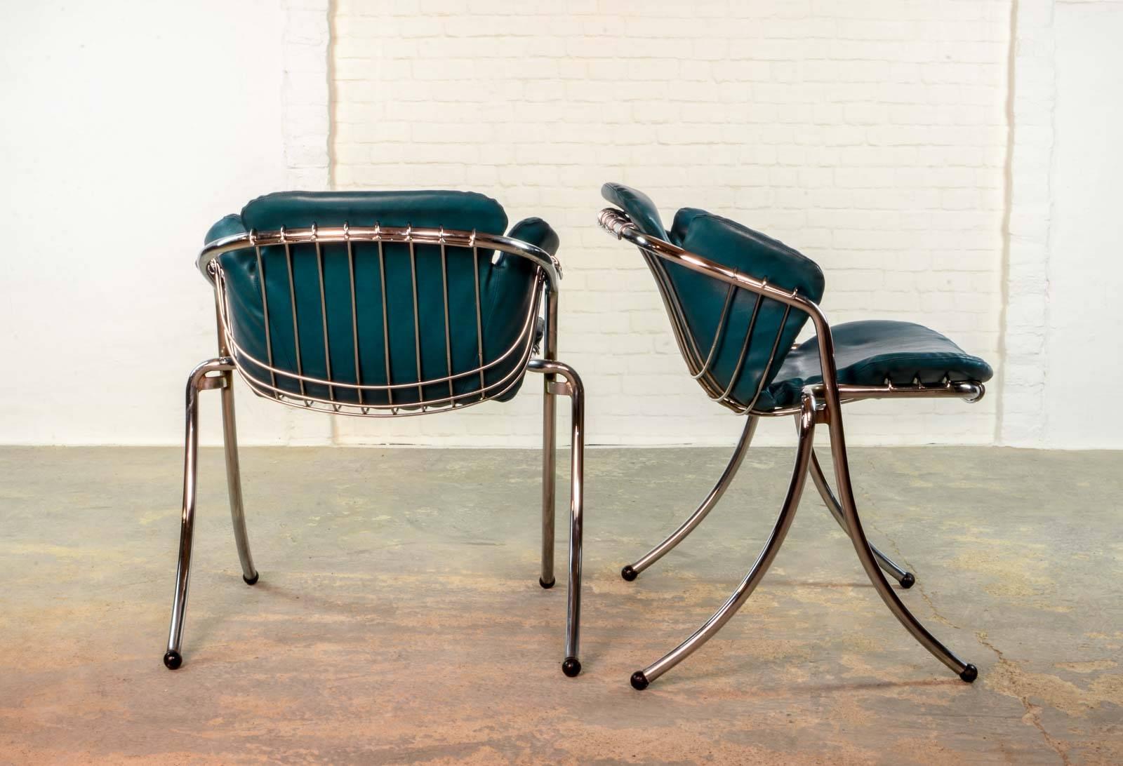 Set of two steel tubular/wire dining chairs 'Lynn' by Gastone Rinaldi for RIMA. Manufactured in Italy. The chairs have a matching cushion made of a very nice aqua blue leatherette. Next to the modern elegancy the design also guarantees a superb