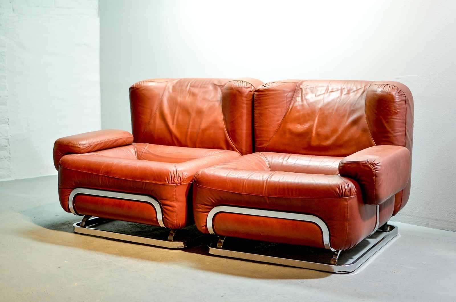 Very nice designed cool midcentury  chestnut brown leather two-seat sofa in style of Tobia Scarpa, manufactured in the 1970s. The -probably Italian - typical seventies design reminds of the 'Madmen' era. The cubic and sturdy shaped sofa offers a