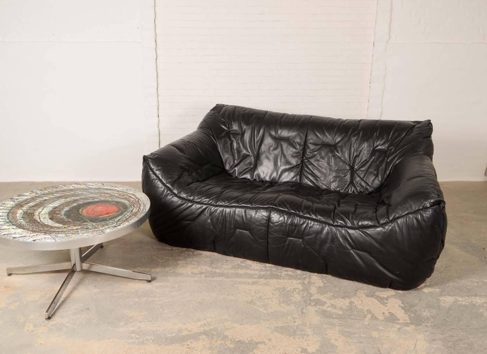 This very comfortable sofa is designed by Hans Hopfer for Roche Bobois in 1984. It is made of beautifully soft black leather upholstered on a soft shell foaming. The condition of the foaming and leather, that features elegant stitching is excellent.