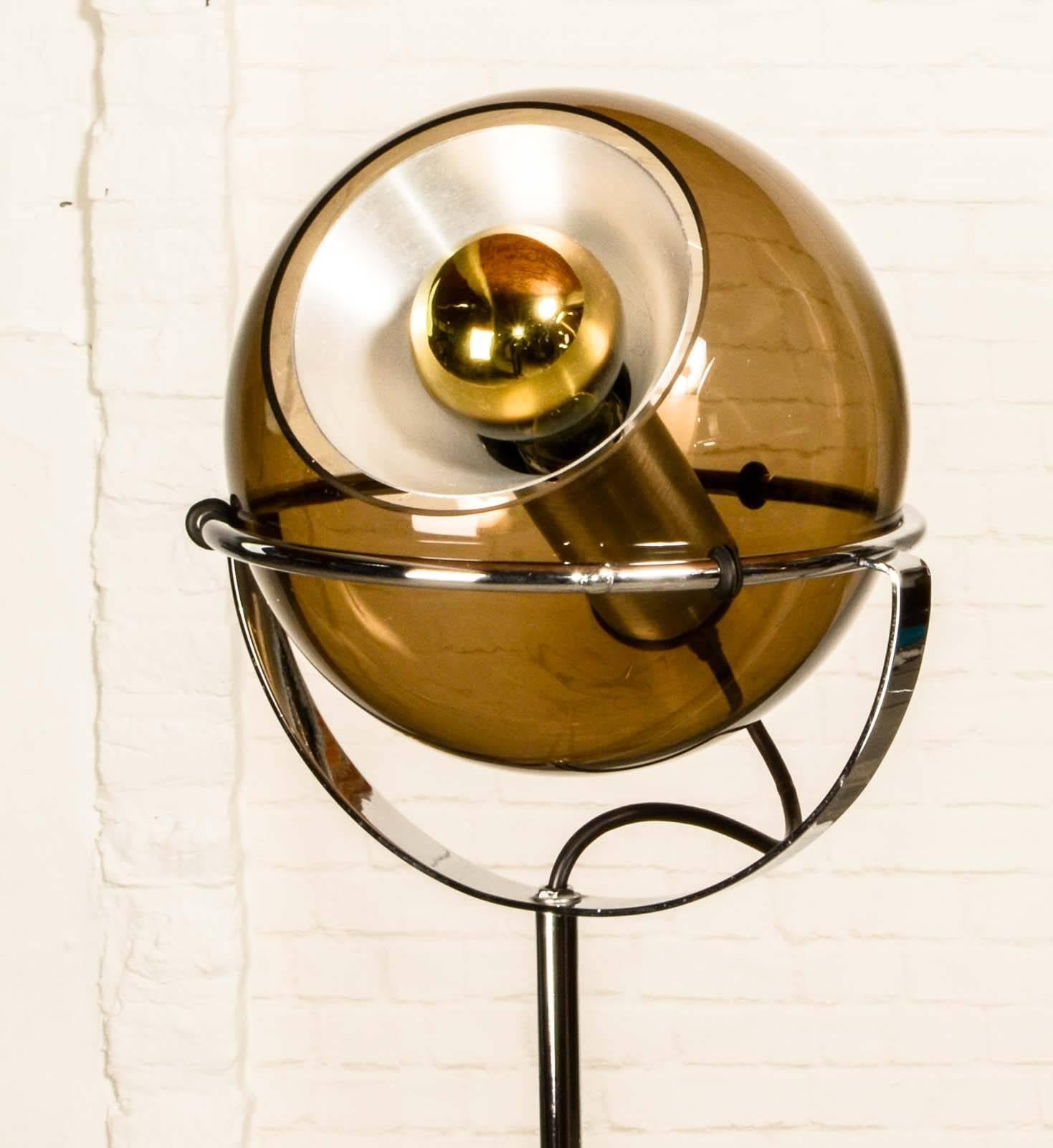 Set of two Dutch design globe floor lamps designed by Frank Ligtelijn. Produced in the 1960s for RAAK Amsterdam. The height of the chrome foot is adjustable up to ca. 150 cm. The smoked glass balls and the chrome standards are both in excellent