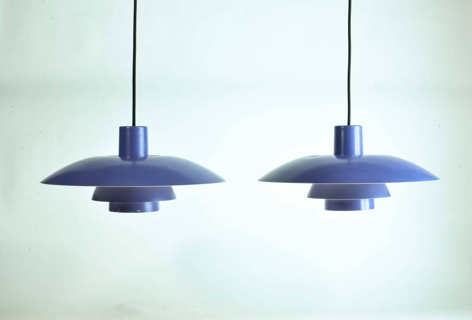 Poul Henningsen PH 4/3 Pendant for Louis Poulsen, Denmark. This model is executed in a refined lavender painted aluminium frame. This famous design stems from Henningsen's own, brilliant three-shade system. The pair is in a very well preserved
