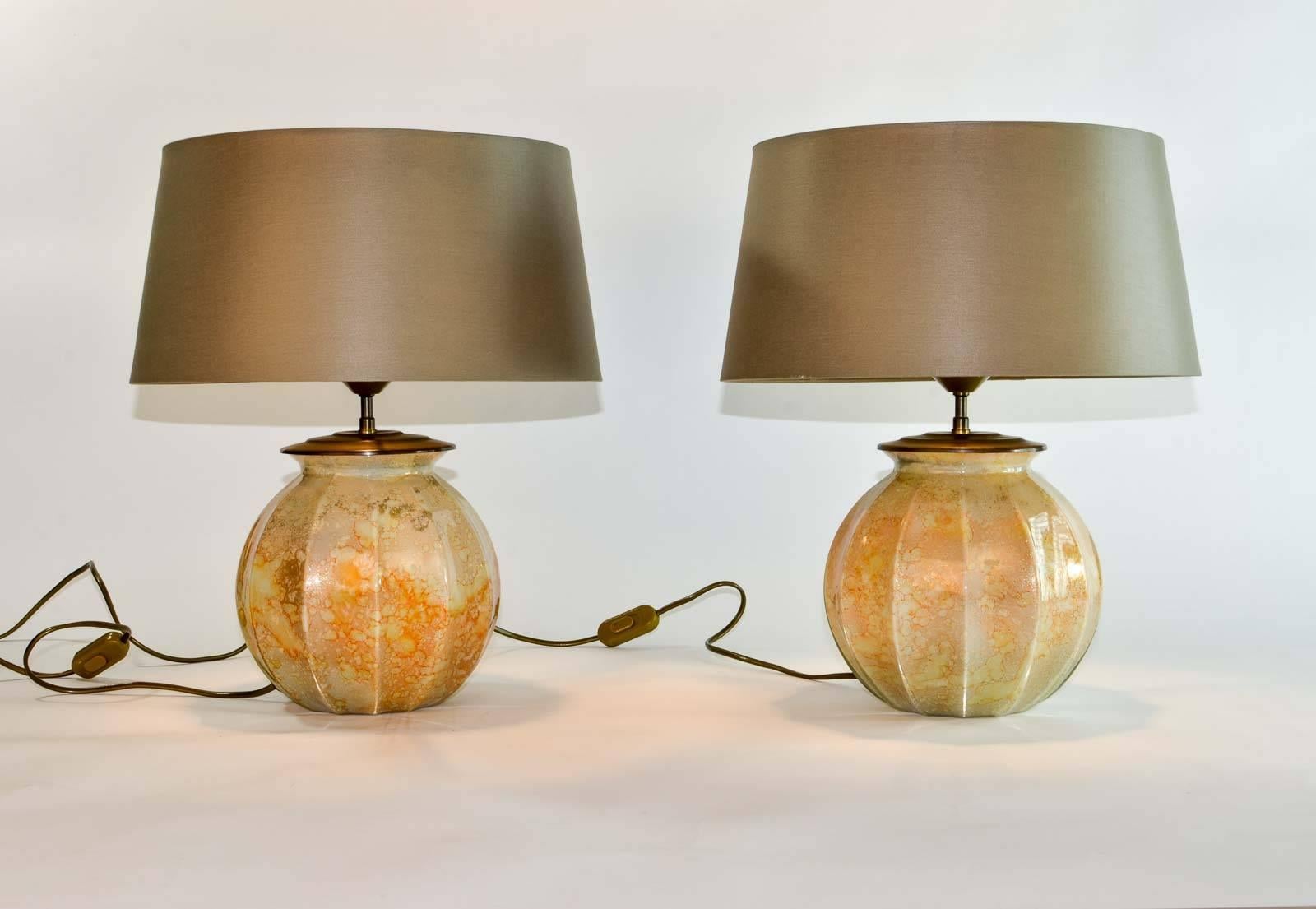 Stunning pair of French handmade glass Laque Line table lamps, 1970s.
The marbled glass foot shows nice color glows of orange, caramel, cream and golddust.
They make a very warm combination with the warm grey colored lampshade on top. Both lamps