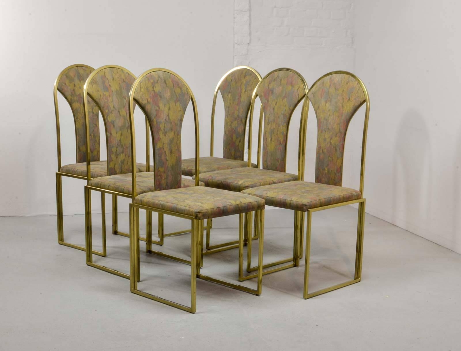 Nice set of six luxurious dining chairs produced by Belgo Chrome in the 1970s. The chairs are upholstered with a distinguished multicolored fabric and fit perfectly in a Hollywood Regency oriented interior. The gold plated frames show some patina.