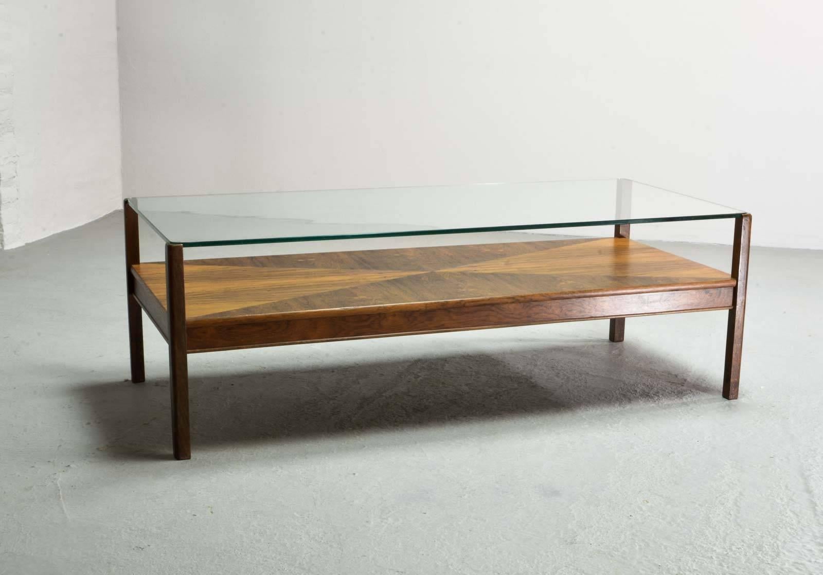 This unique rosewood coffee table with glass tabletop is manufactured with great craftsmanship by Fristho, The Netherlands in the 1960s. The glass top gives full sight on the beautiful mosaic structured rosewood layer underneath. The table is in a