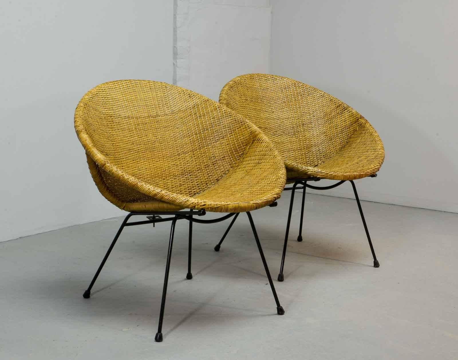 Very distinguished set of circle shaped woven rattan side or cocktail chairs on a black lacquered steel base. 'Less is more' is recognizable in this timeless minimalistic Dutch, design by Dirk van Sliedregt for Rohé, the Netherlands. This authentic