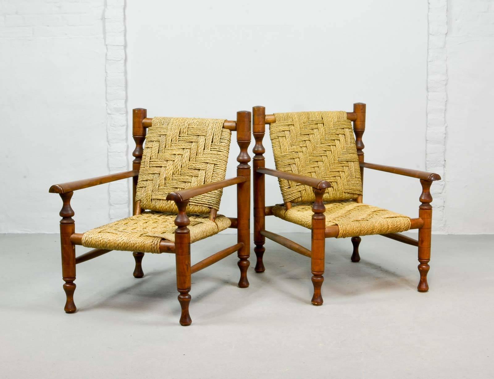 A rare pair of lounge chairs in the style of Charlotte Perriand. The frame of the chairs are build out of ashwood and come with a woven sisal rope seat and backrest. The chairs do have a craftsmanship structure and are beautiful patinated. They