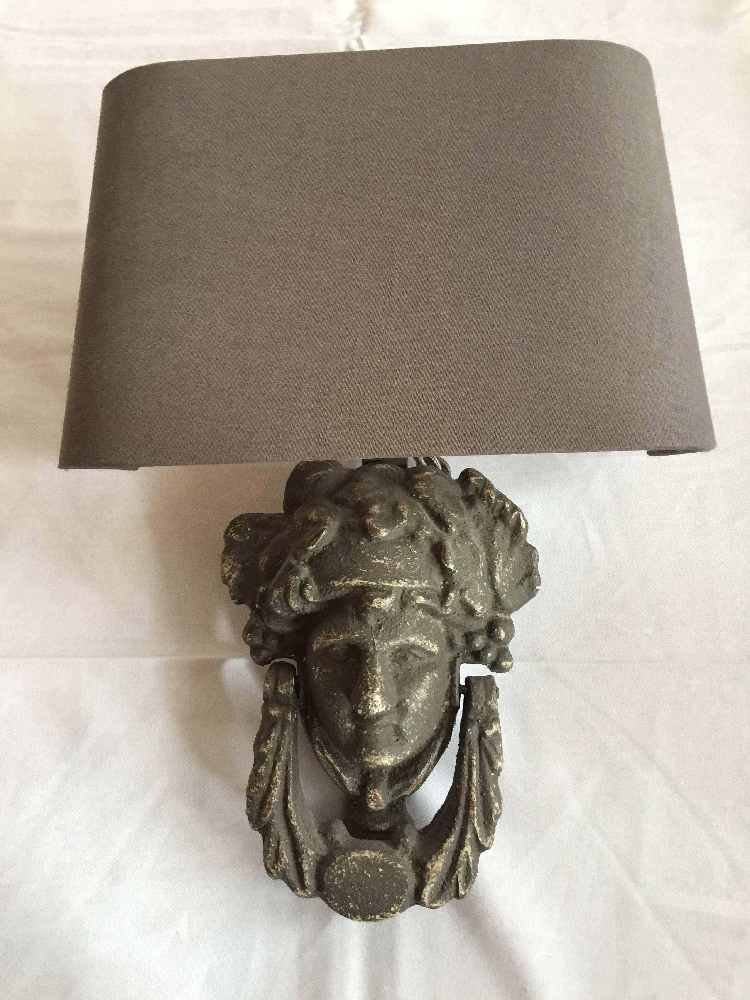 Purchased at Paris flea market at Paul Bert Serpette. Newly hard-wired pair of sconces. Made from working door knockers made of iron. Featuring image of goddess Athena. Custom grey linen shades.