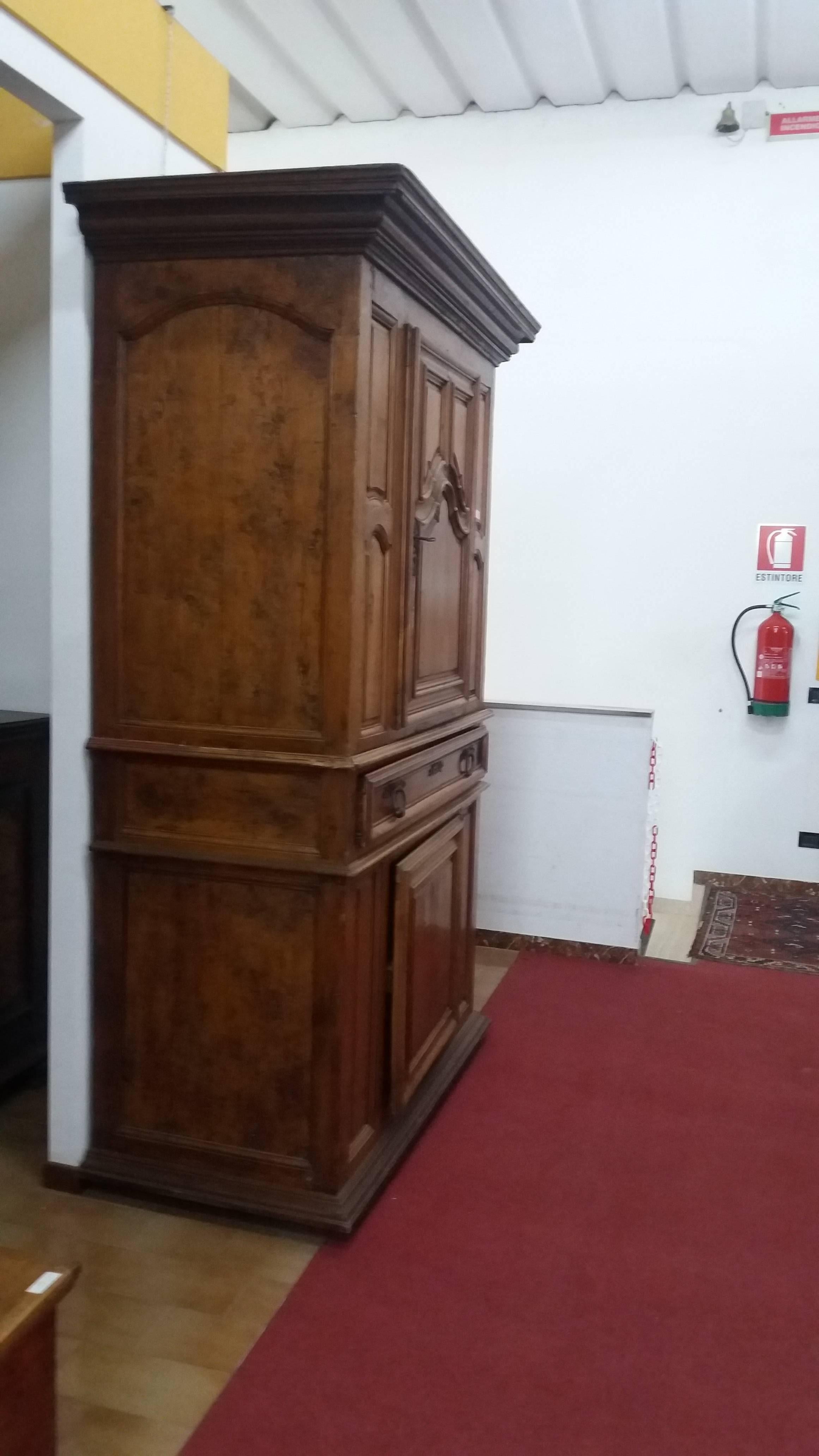 This is an cherry carved cabinet from Toscany
The handles are wrought iron
It has to be restored but it is complete 
Measures: 240 height x 153 width x 70 depth.