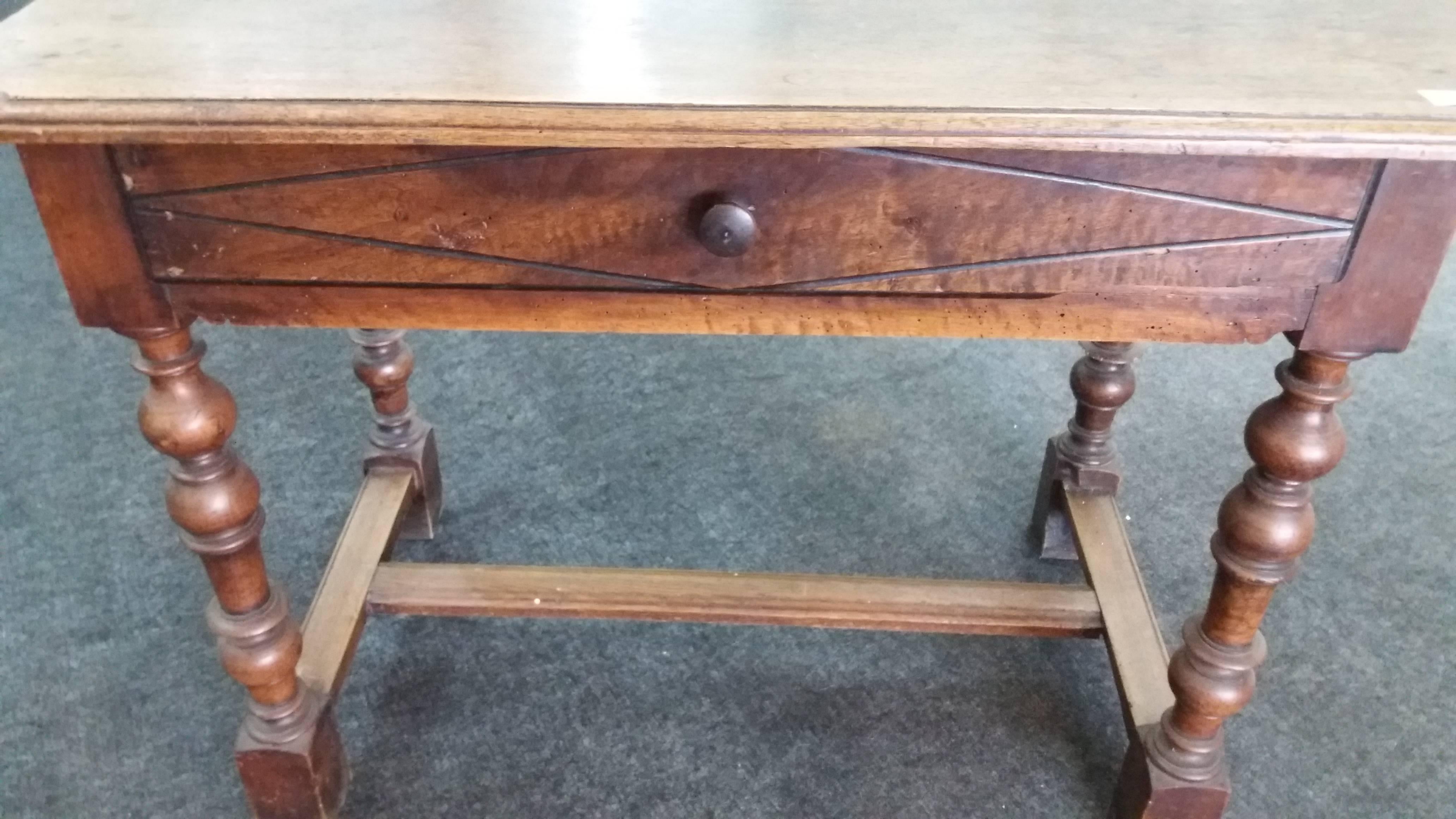 This desk has a drawer. It is made of walnut wood. It is French, 18 century. It has to be restored.