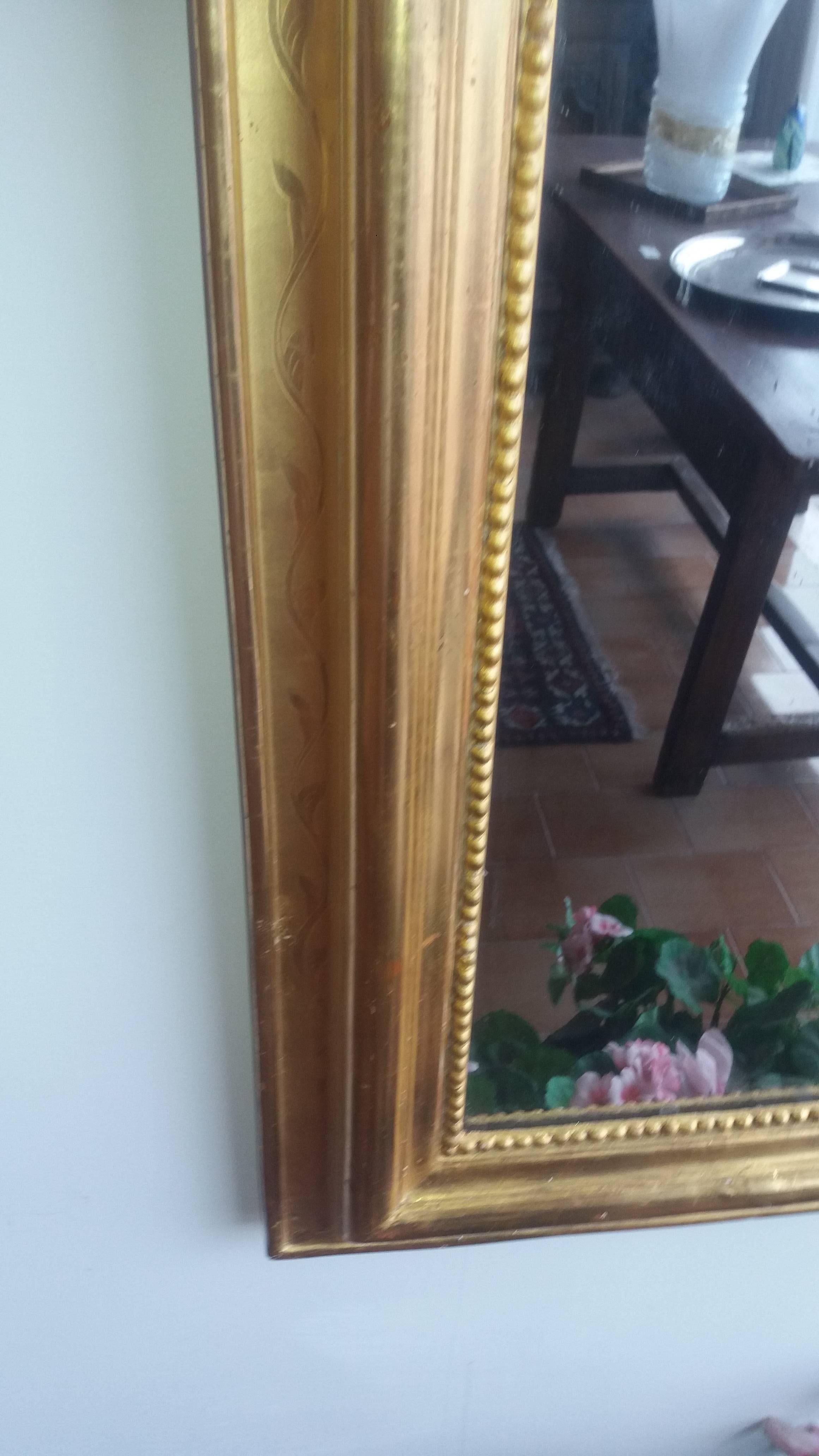 19th century gold wood and plaster mirror.
Measure: 136 cm height and 85 cm width.