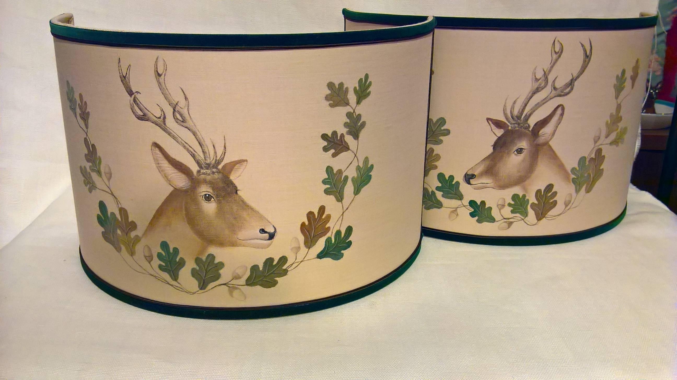 Pair of  hand-painted lampshades with deers and oak leaves in brown and green.
The dears and oak leaves are painted by hand on linen with a green velvet paspol. Iron angels to supply electricity will be delivered with the shades. See last picture.