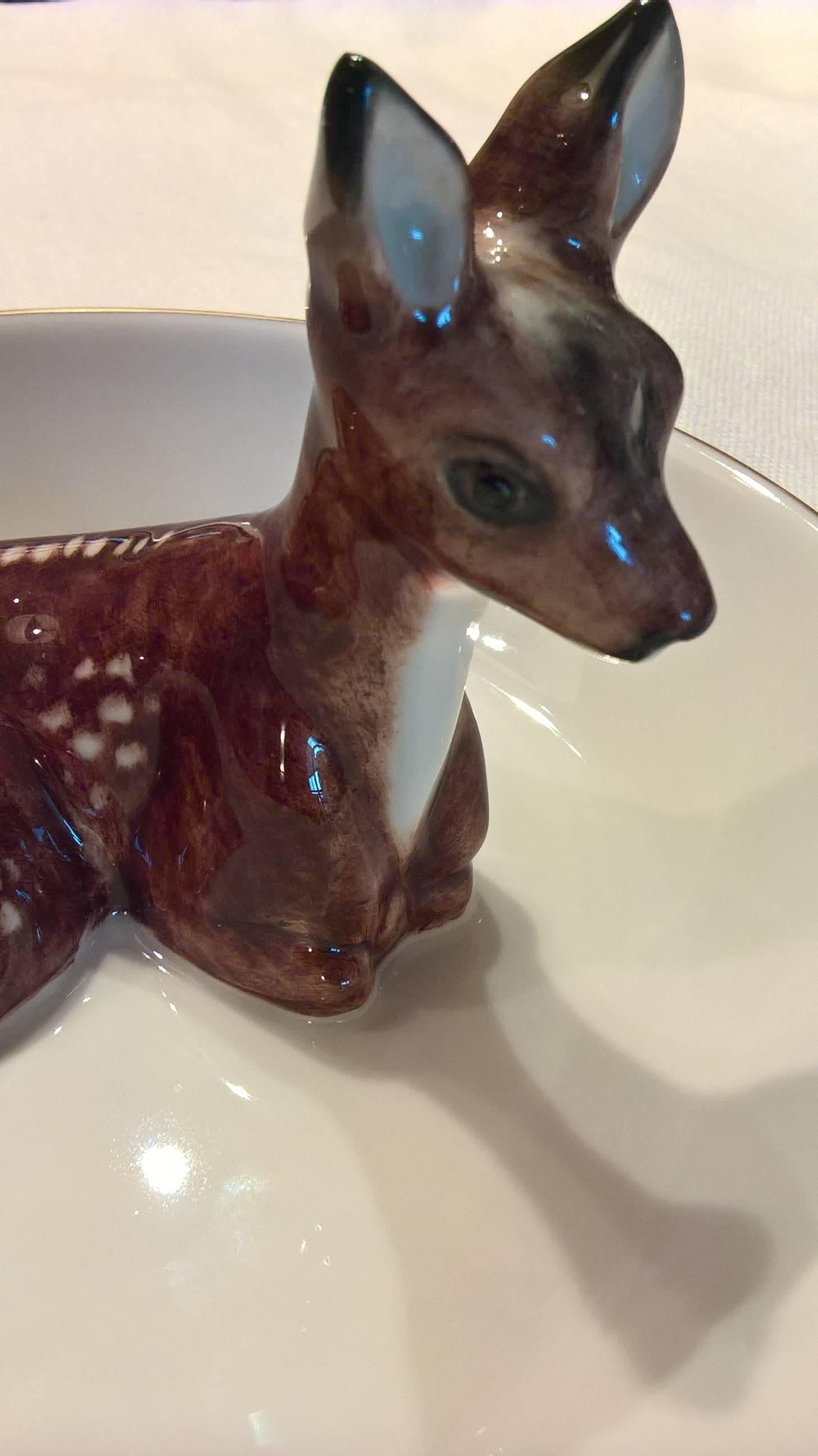 Hand-painted porcelain dish for serving sweets or nuts with a naturalistic bambi figure in the center of the dish. The bambi figure and the bowl are completely handmade in Bavaria. Hand-painted bambi figure with a green line and platinum