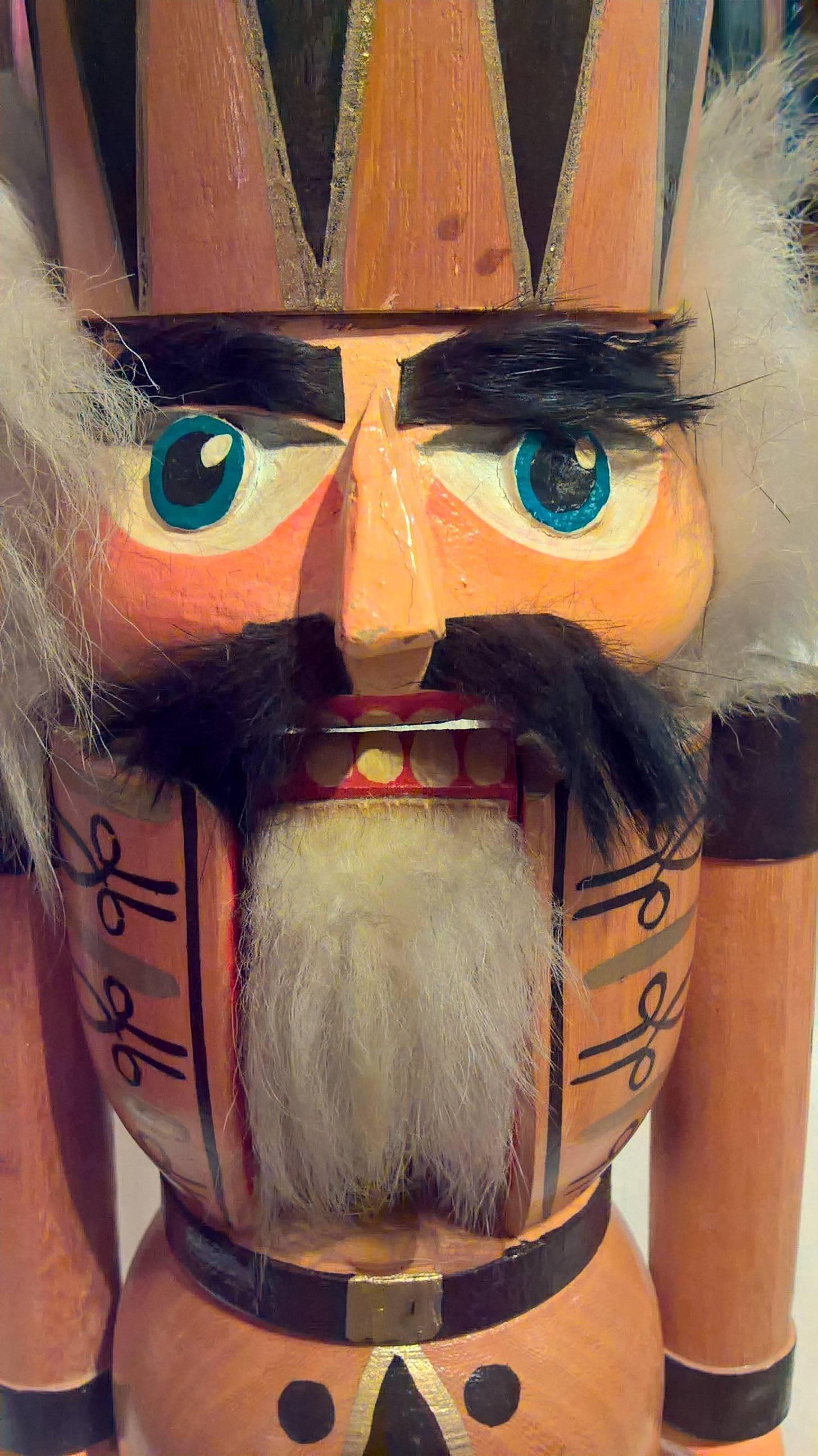 Large wooden nutcracker figure from the Erzgebirge. The region Erzgebirge formerly Eastern Germany is famous for this special kind of nutcrackers, where intricate carving has been their home. Completely hand painted and decorated with faux fur.