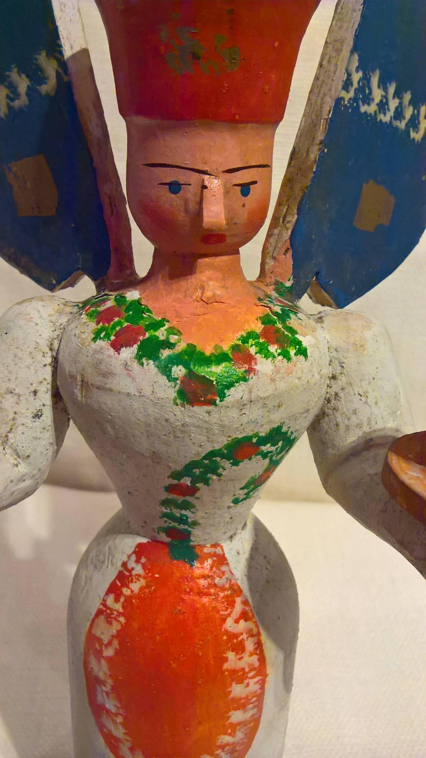 Beautiful colored wooden angel figure from the Erzgebirge. The region Erzgebirge formerly Eastern Germany is famous for this special kind of Christmas figures, where intricate carving has been their home. Completely hand painted and decorated.