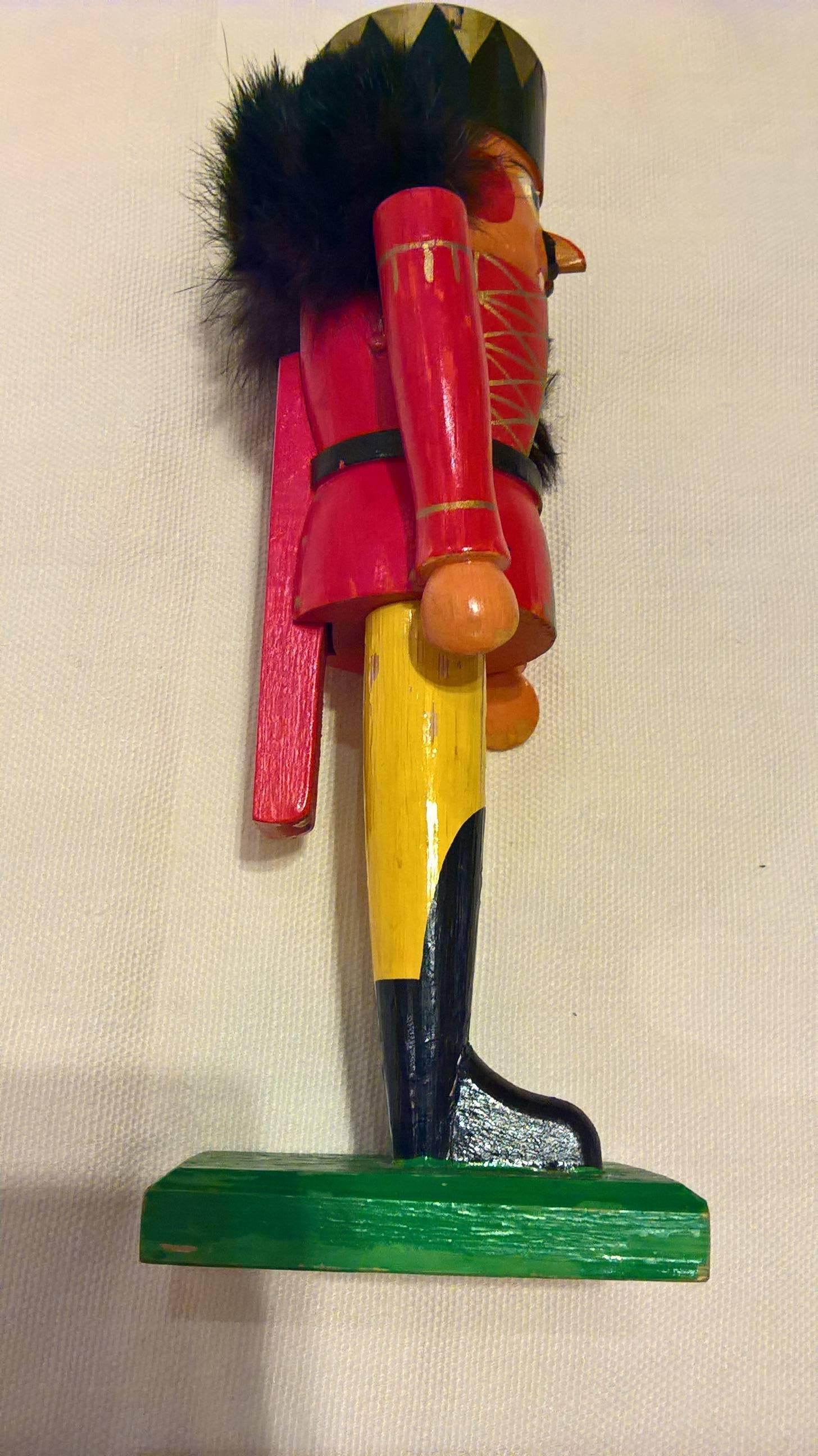 Large wooden nutcracker figure from the Erzgebirge. The region Erzgebirge formerly Eastern Germany is famous for this special kind of nutcrackers, where intricate carving has been their home. Completely hand-painted and decorated with faux fur.