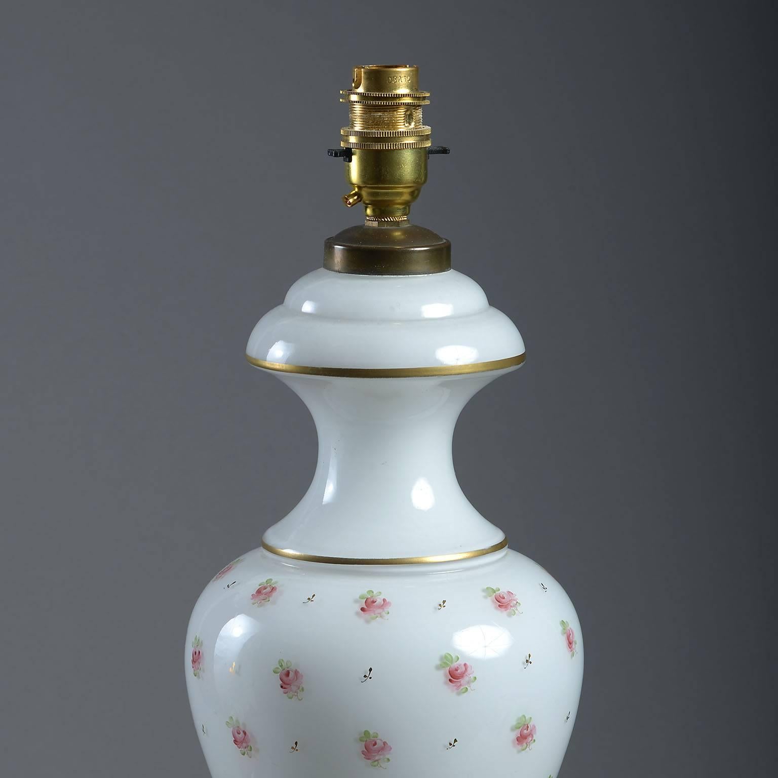 The baluster form decorated with sprigs of rosebuds on a milky-white ground.
Recently re-wired

French, 20th century.
 