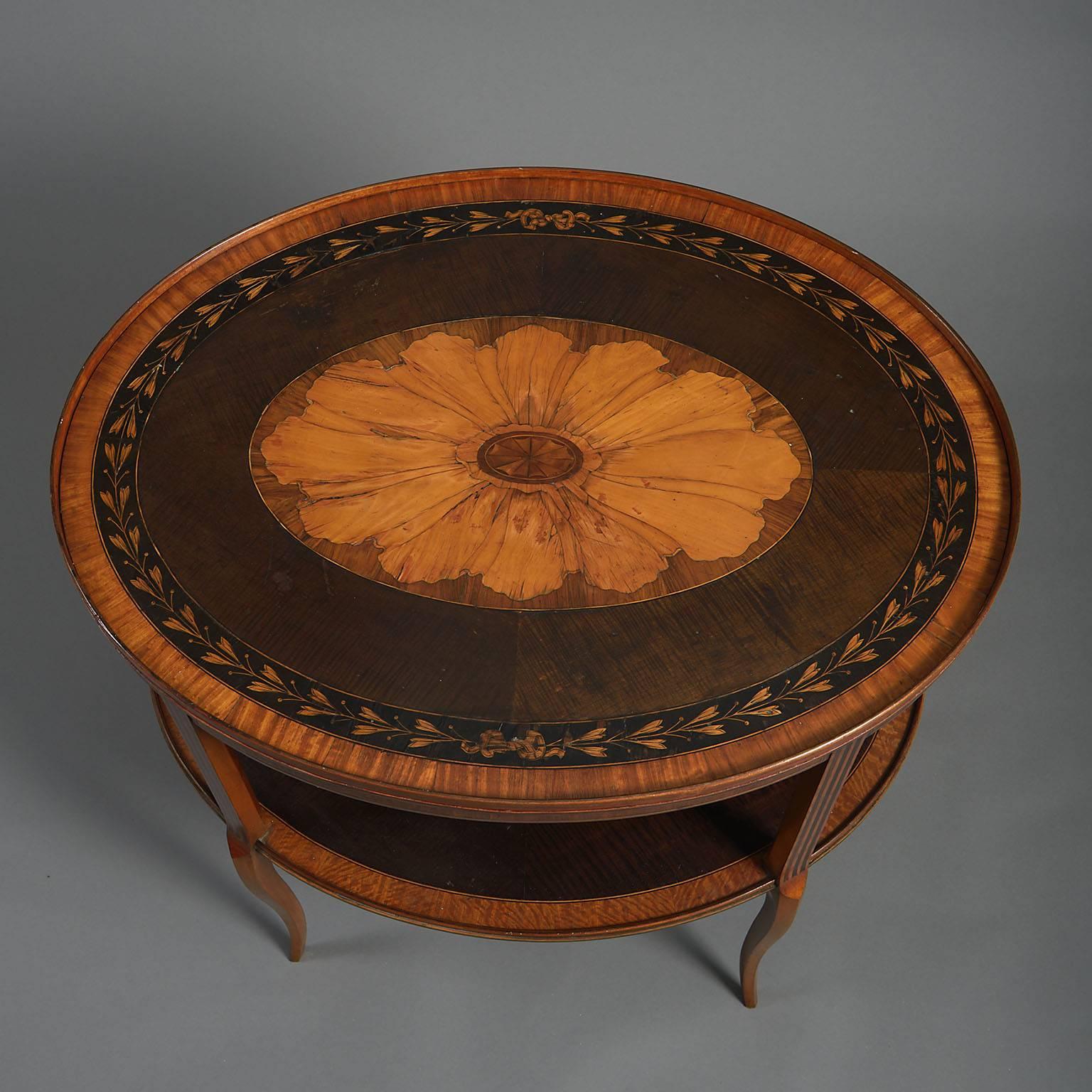 George III oval tray-top table
Inlaid in satinwood and sycamore with large central patera and an outer border of engraved leaves, raised on a later satinwood stand to form a table, with conforming under-shelf

English, circa 1785 and