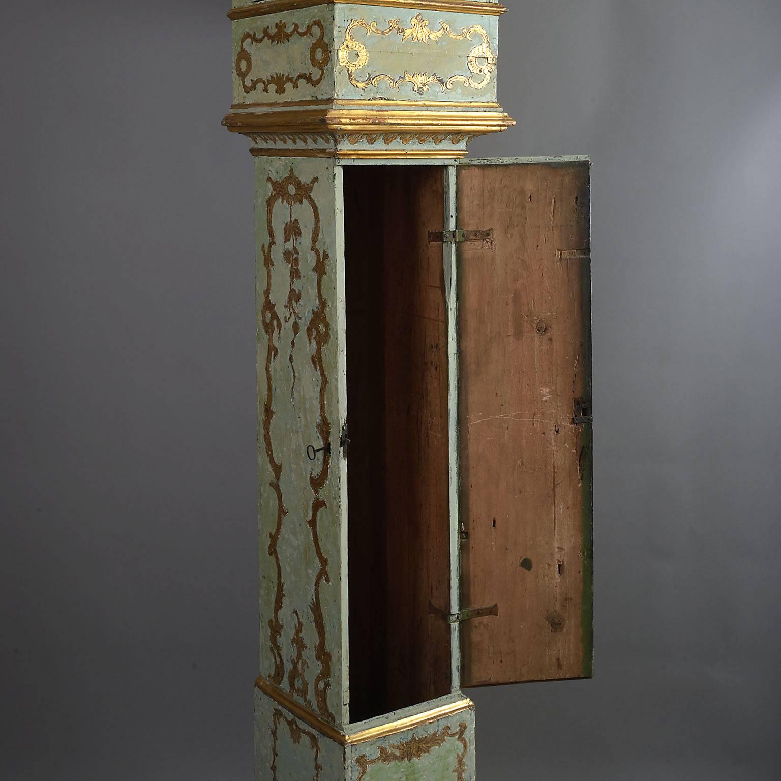 A rare Italian mid-18th century painted and parcel-gilt longcase clock of grand scale
The tall case decorated with carved and gilt Rococo scrollwork on an eau de nil ground. The glazed pyramidal top above the fully glazed hood with three doors