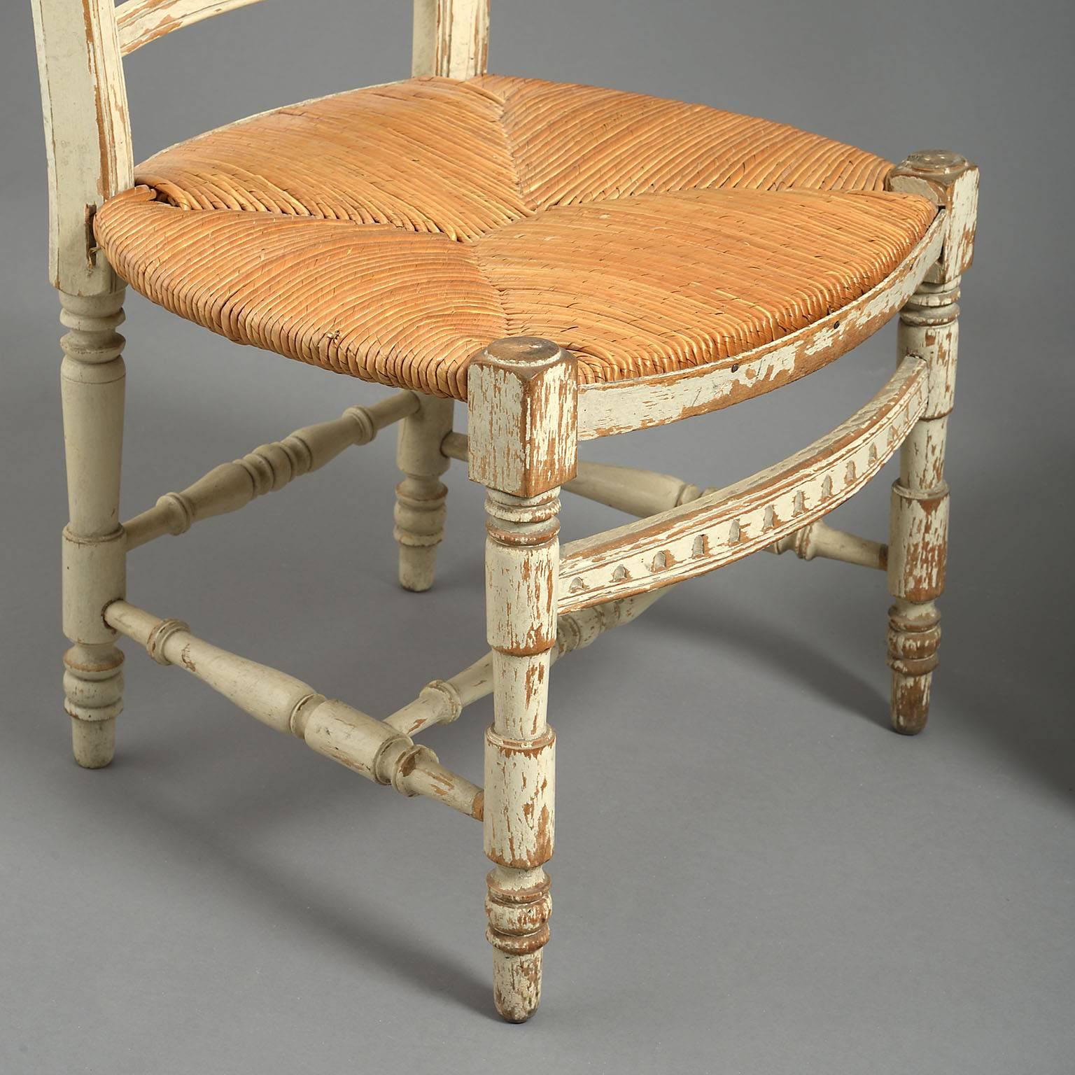 The high backs with acorn finials and stylized wheat-sheaf splat leading down to a low rush seats with turned legs and H-stretchers.



 
