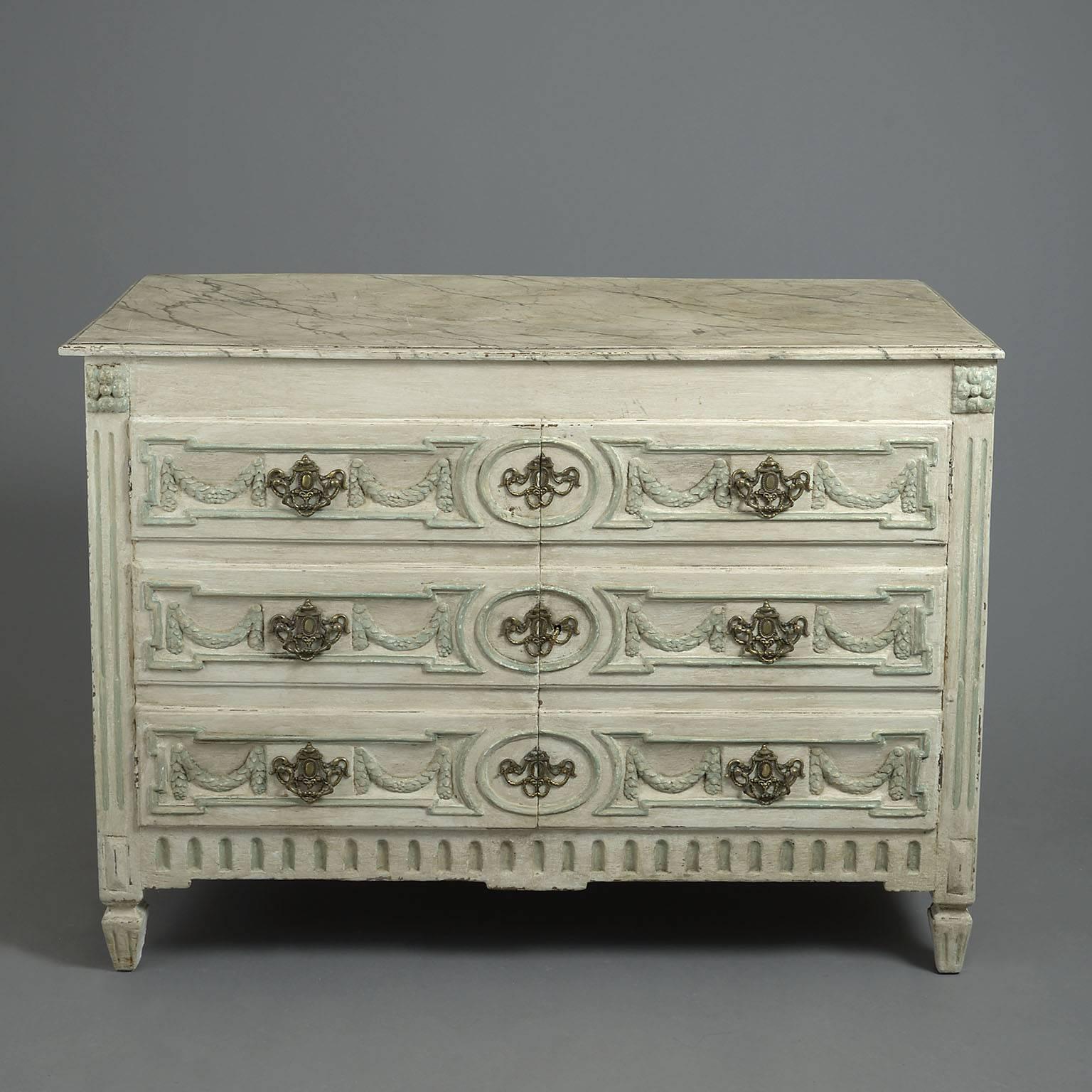 The faux marble top above a pair of cupboard doors panelled to look like three drawers with original neoclassical brass handles and escutcheons opening to reveal a shelved interior and raised and fielded panelled sides standing on tapering feet.