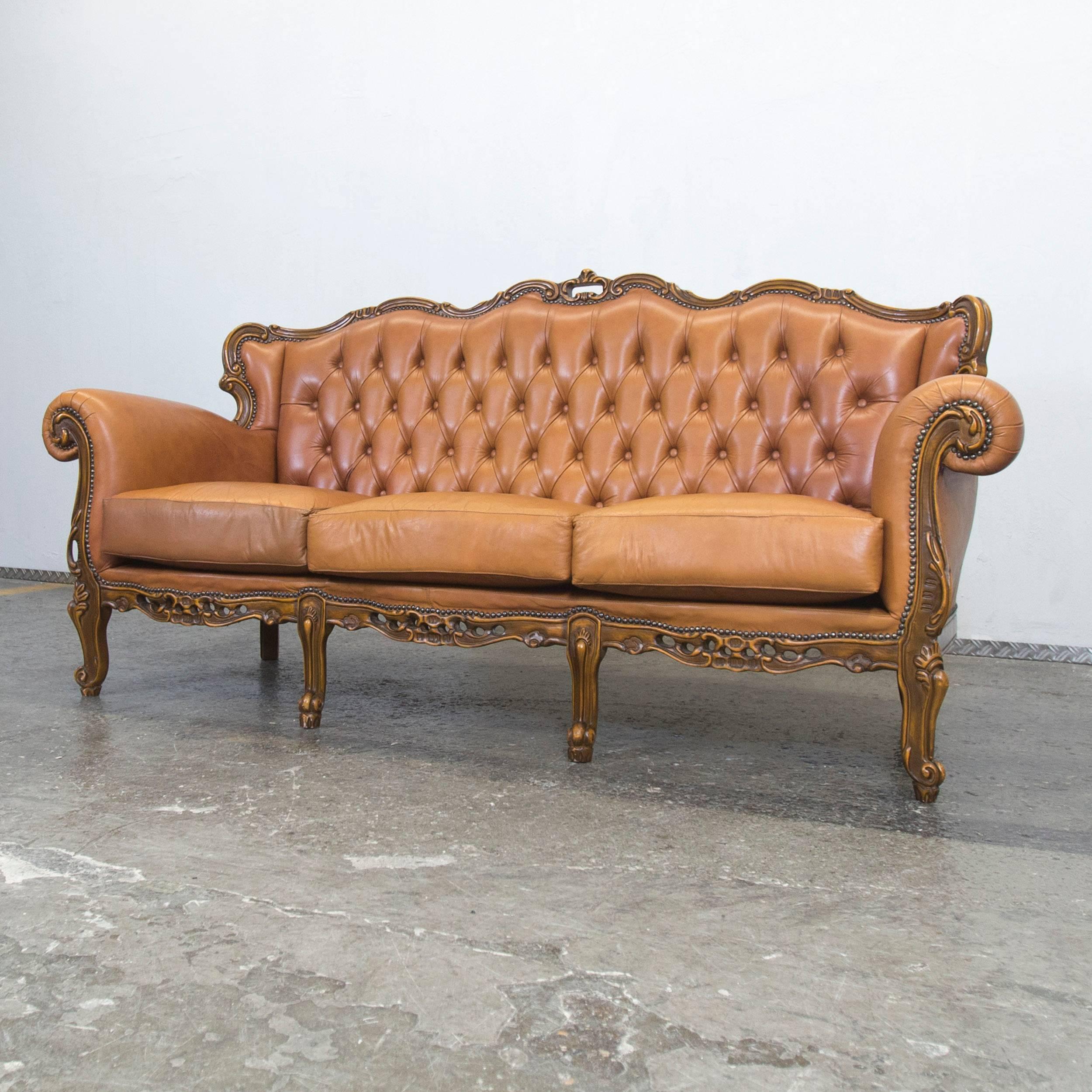 Elegant cognac colored leather Chesterfield sofa, with an intricate vintage design.