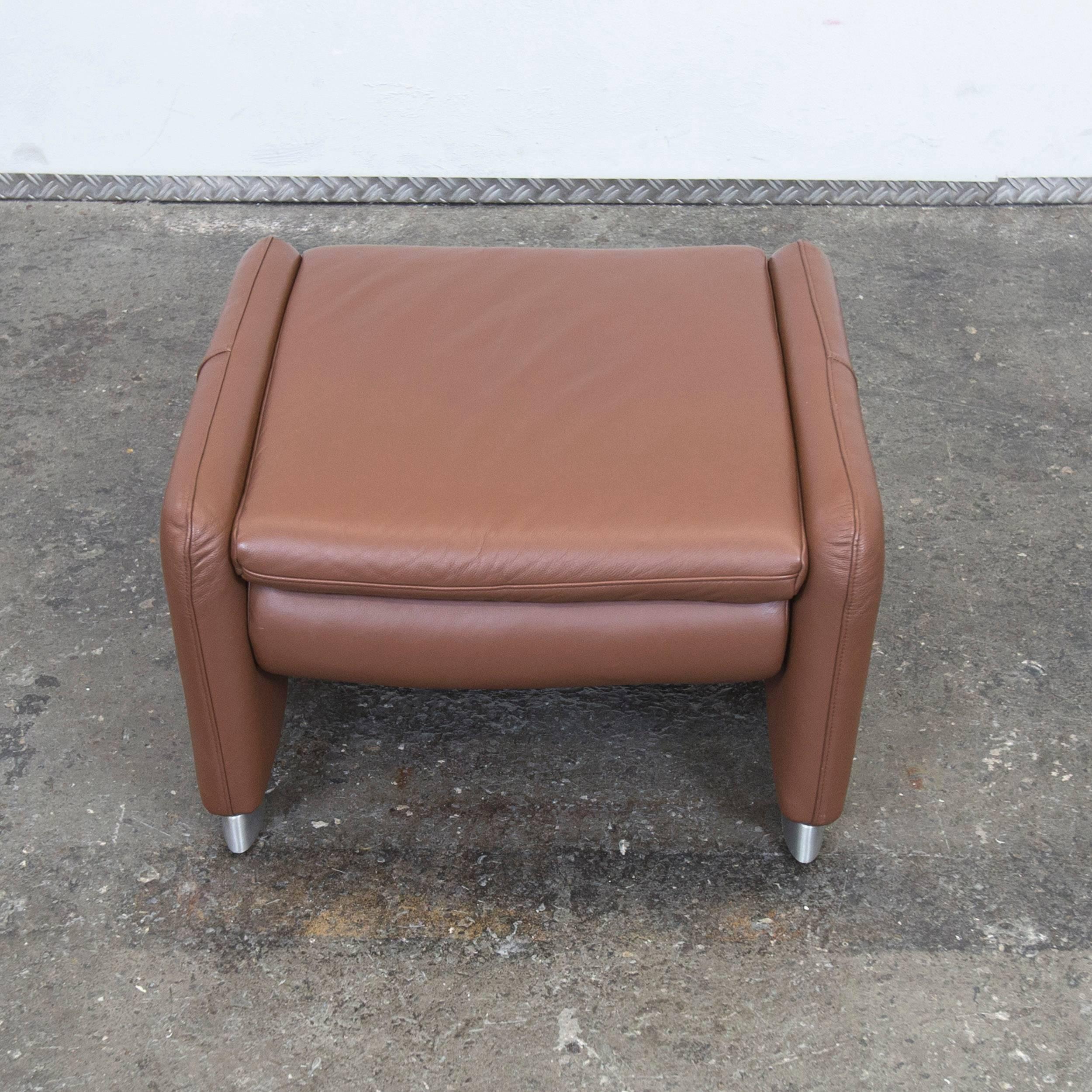 Brown colored Hülsta designer footstool with a modern style, designed for pure comfort.
