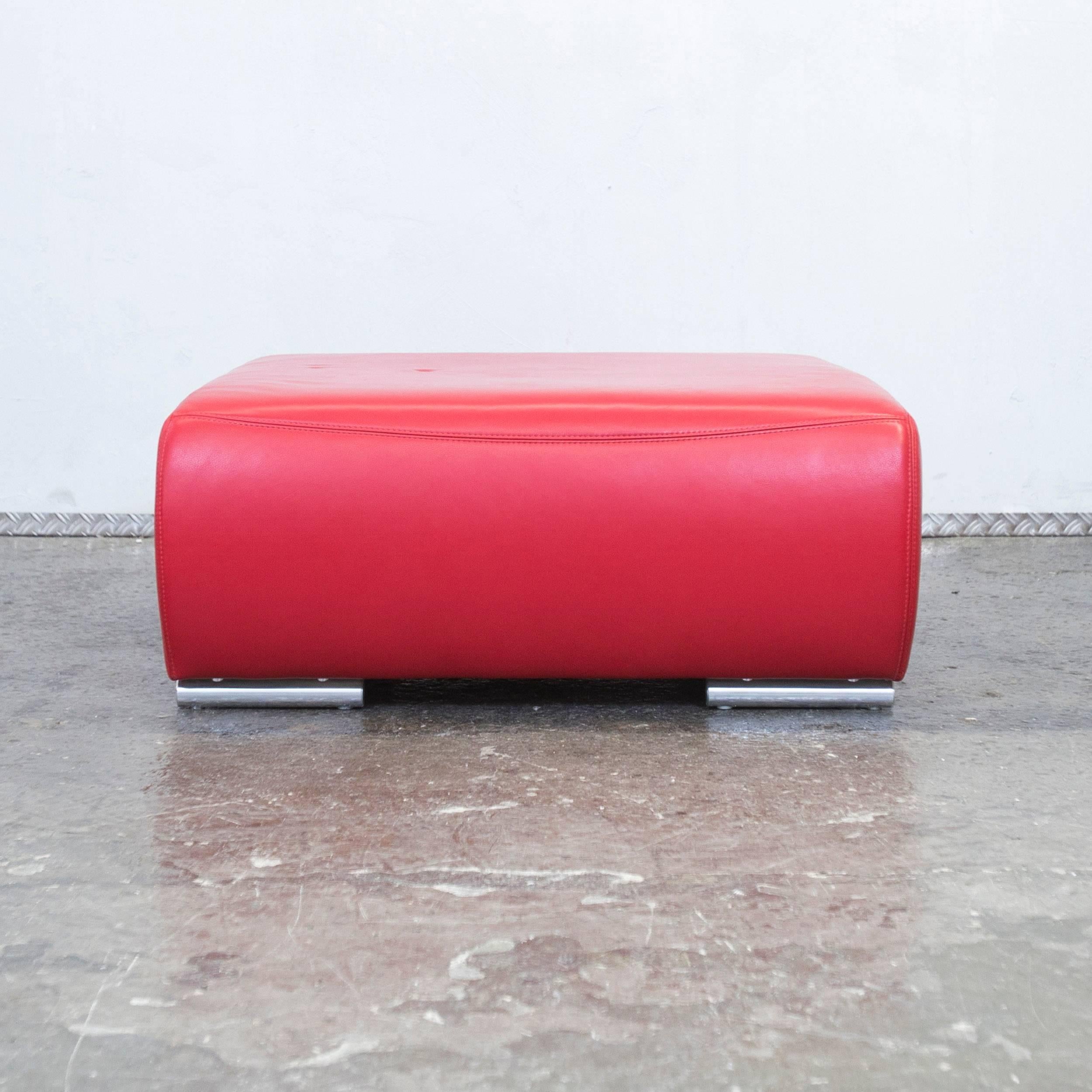 Red colored Hummel designer footstool, designed for pure comfort and flexible placing.