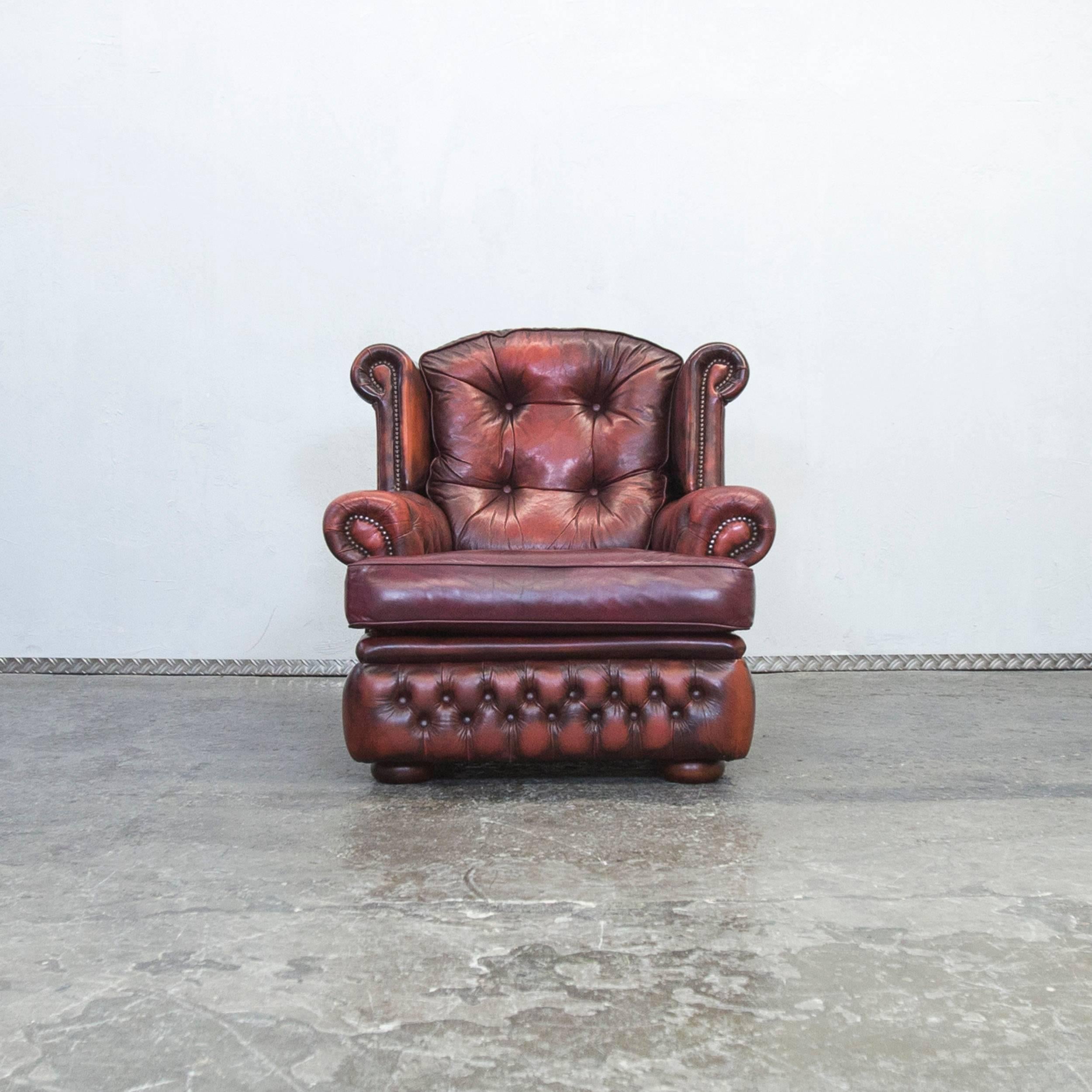 Red and brown colored Chesterfield leather armchair in a vintage style, designed for pure elegance and comfort.