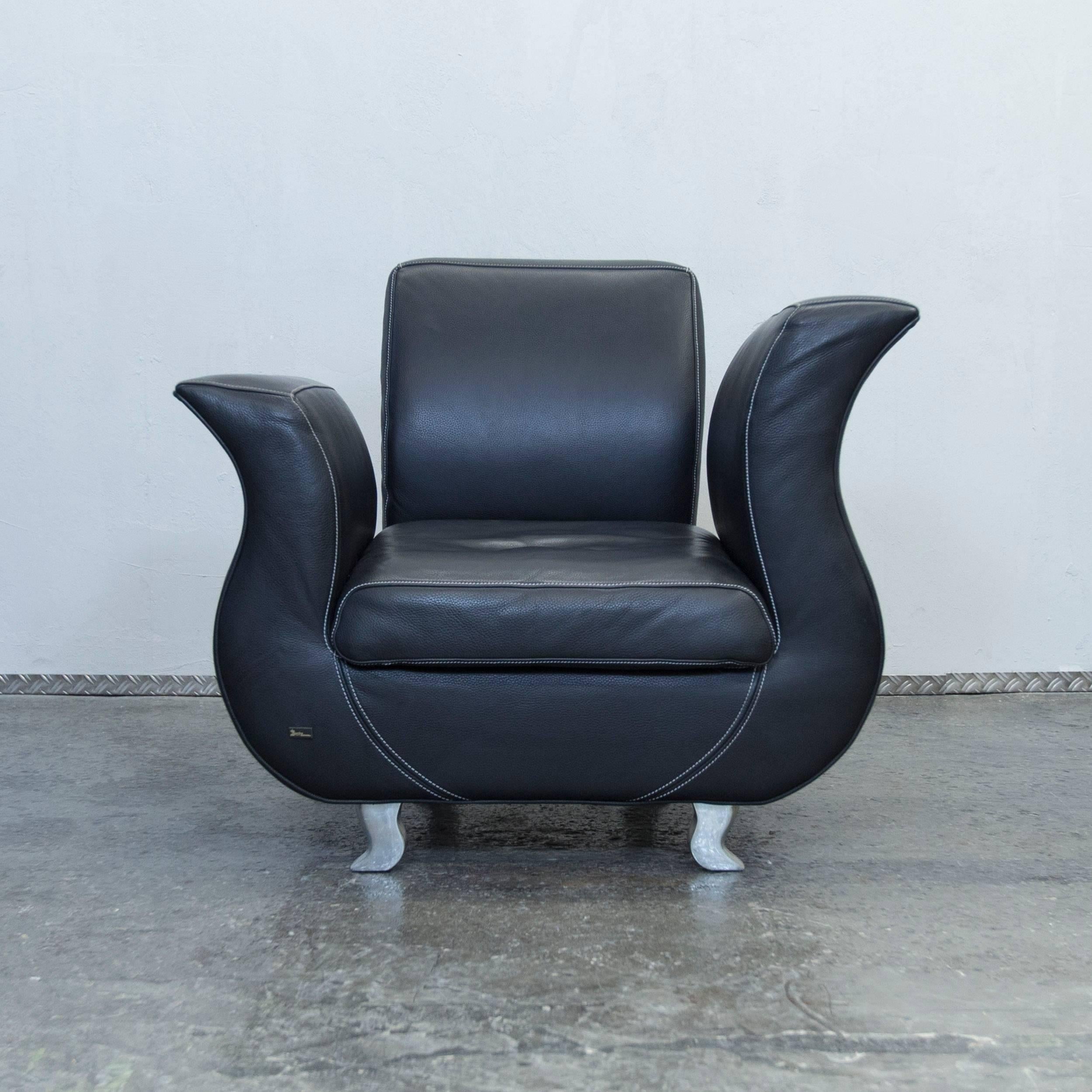 Black colored original Bretz Moon designer leather armchair in a minimalistic and modern design, made for pure comfort and elegance.