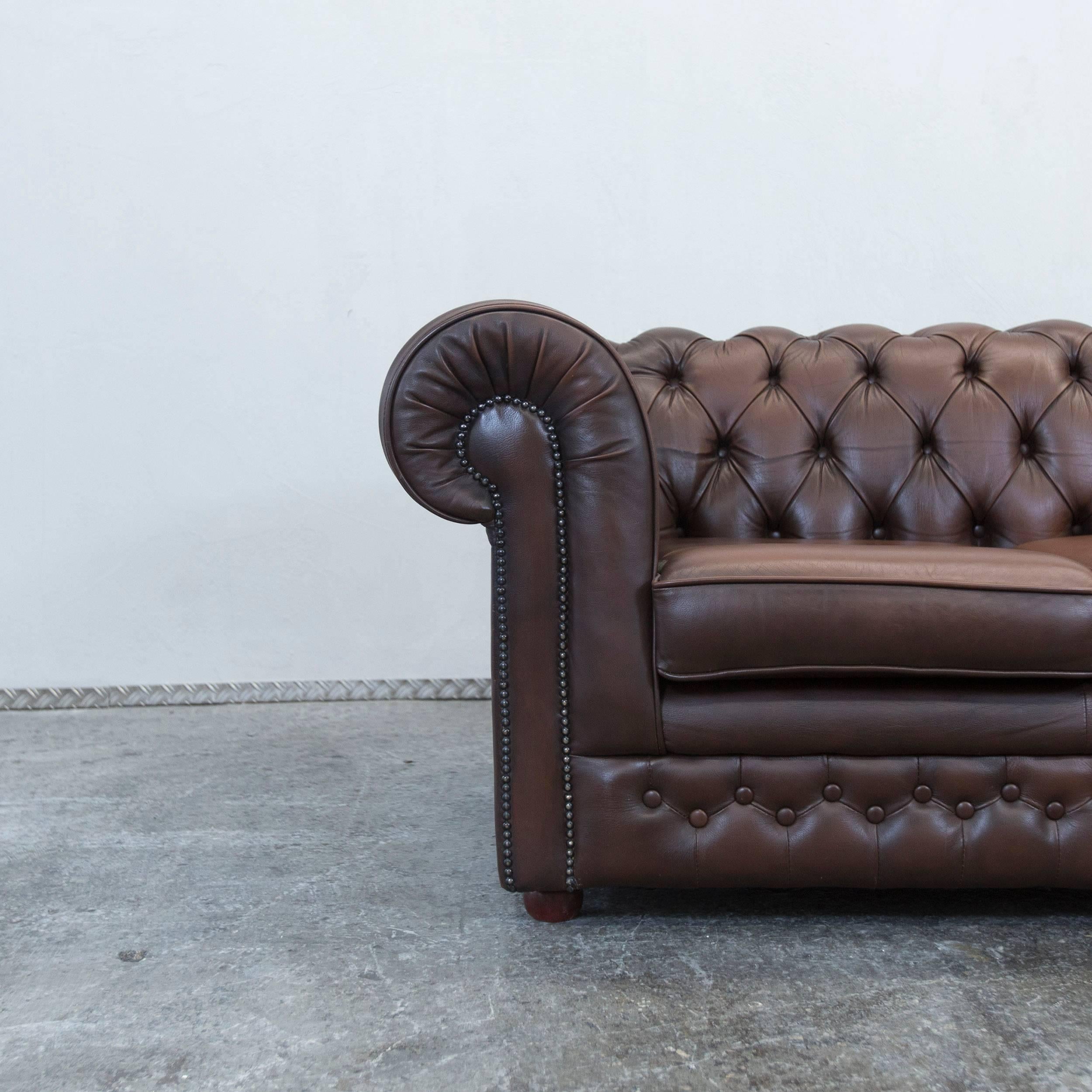 Brown colored original Thomas Lloyd Chesterfield leather sofa in a vintage style, made for pure comfort and elegance.