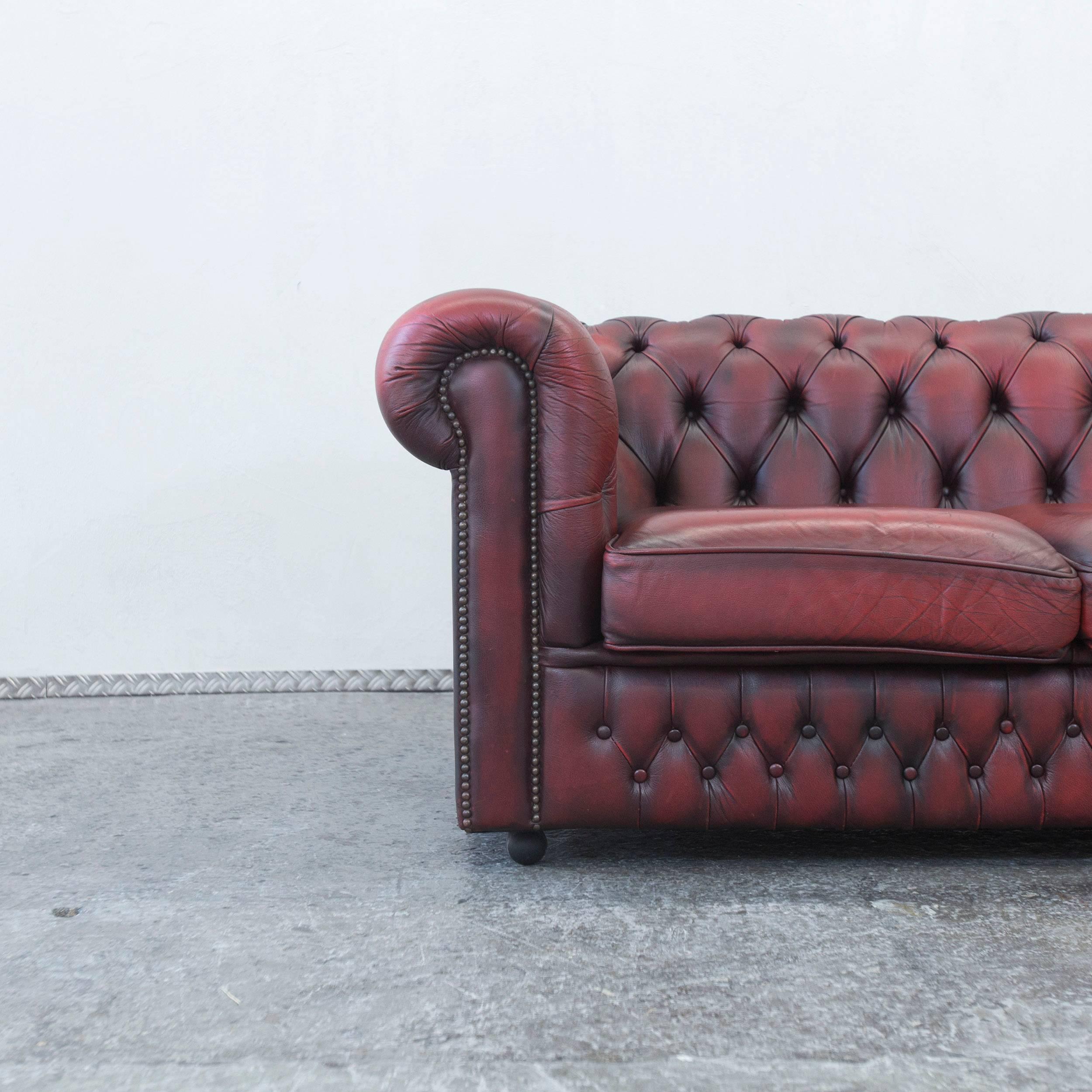 Oxblood red colored Chesterfield leather sofa in a vintage style, designed for pure comfort and elegance.